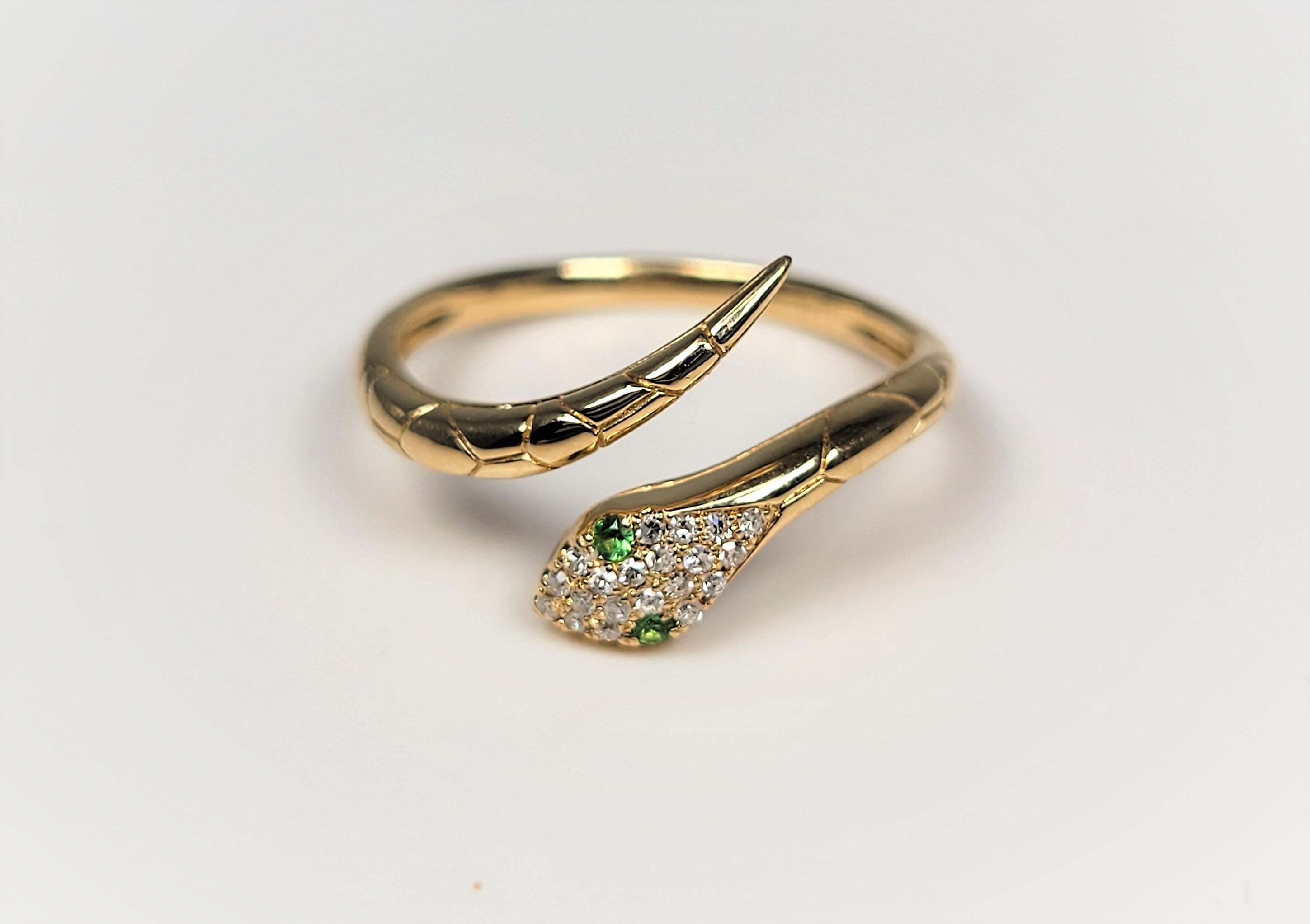 In 14 karat yellow gold, this fun diamond and tsavorite snake ring isn't just for the snake lover!