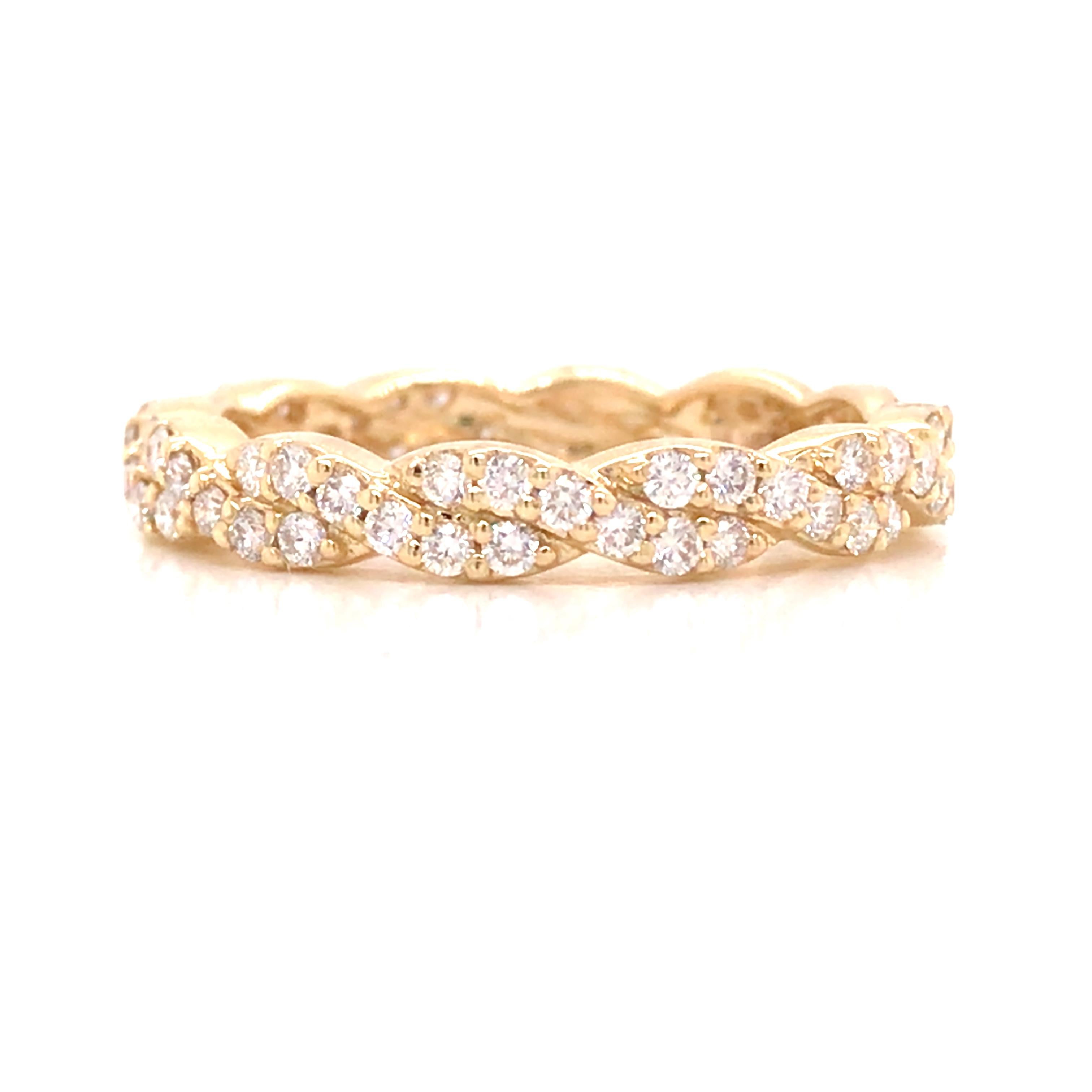 Diamond Twist Band in 14K Yellow Gold.  (54) Round Brilliant Cut Diamonds weighing 0.54 carat total weight, G-H in color and VS-SI in clarity are expertly set.  The Ring measures 1/8 inch in width.  Ring size 6 1/2. 2.33  grams.