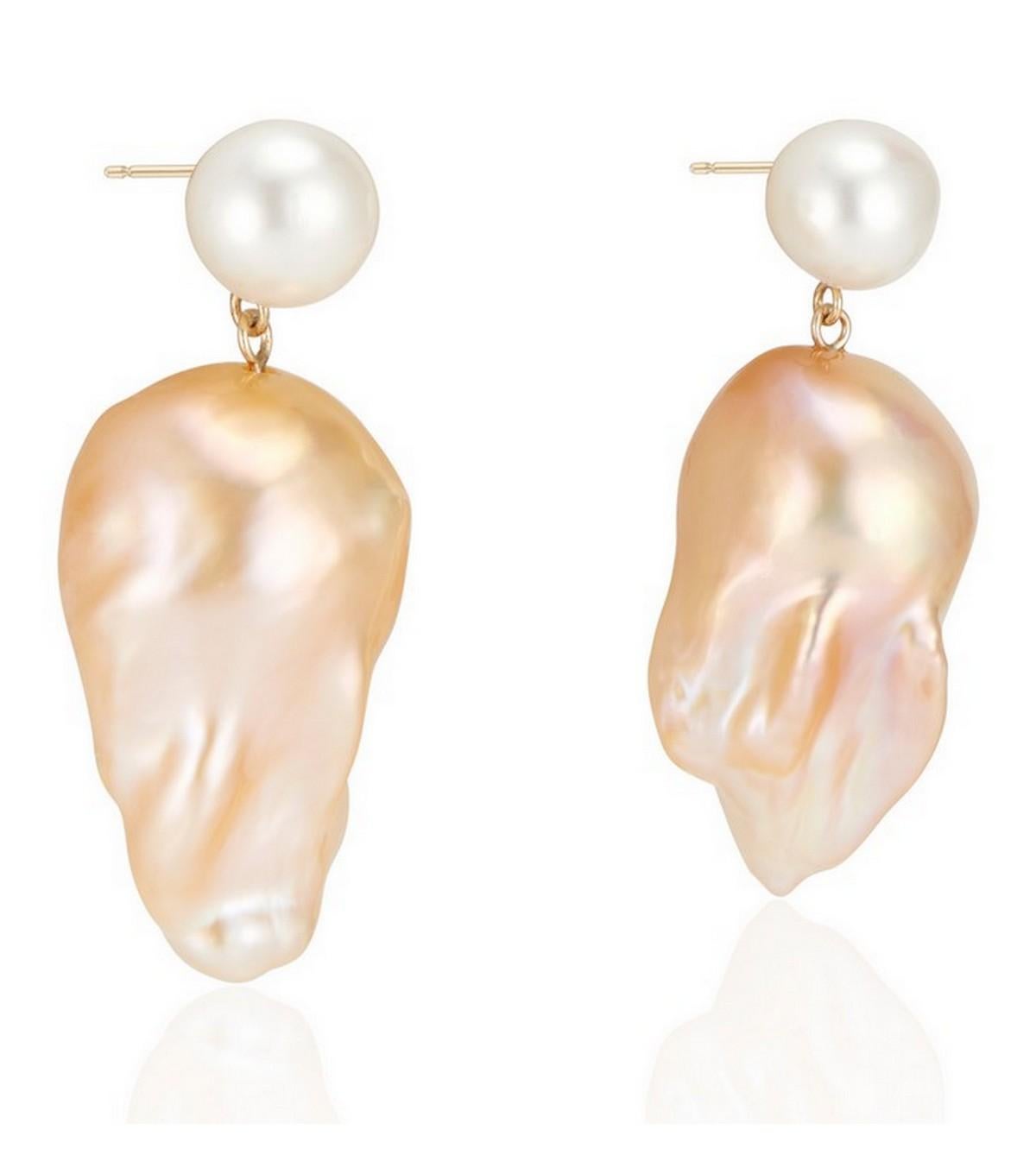 One of our favorites of our new collection, these Double Bubble earrings feature an 8- 8.5 mm white freshwater round pearl with a natural golden hue freshwater baroque pearl set on 14k Yellow gold post.

Make a statement with these unique golden