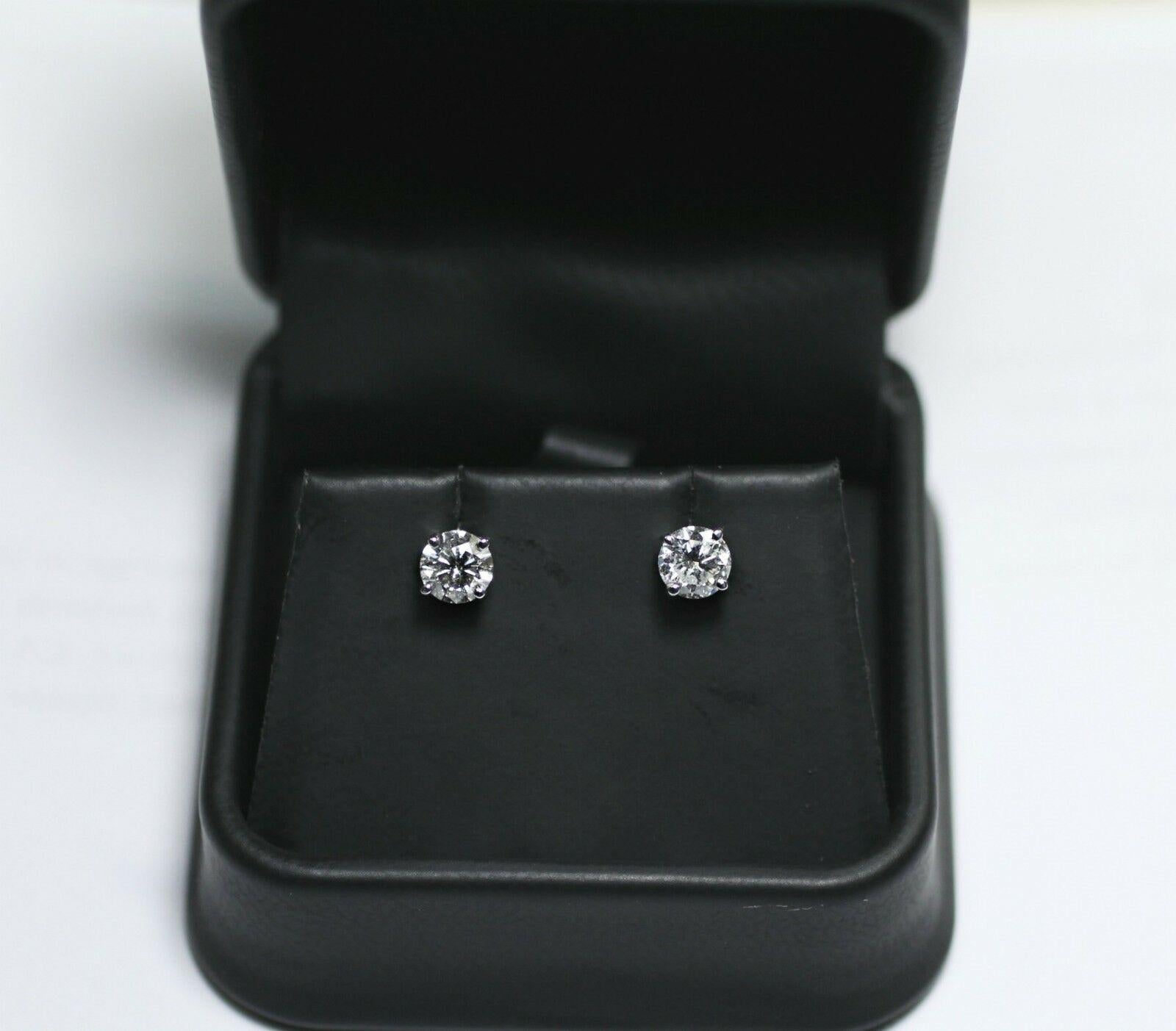 Diamond Specifications
Main Stone:  
Shape:  Round  
Carat Total Weight:   1.15Ctw
Color:    EF 
Clarity: SI3 
Jewelry Specifications
Brand:Custom
Metal: 14K White Gold
Type: 4 prong stud earrings
                                              