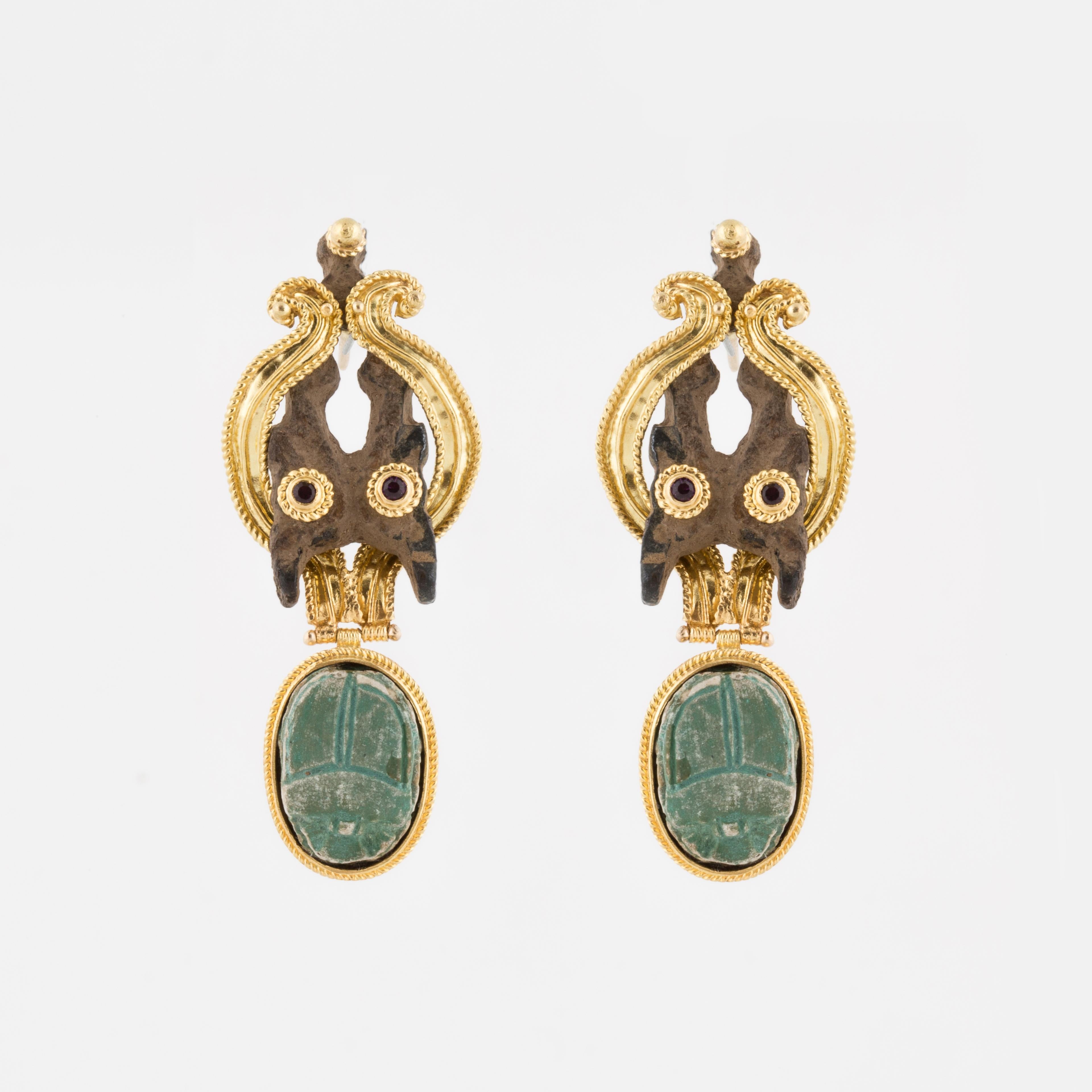14K yellow gold earrings featuring a faience scarab in each one.  There are also vintage pieces of metal highlighted with two (2) each tourmalines and amethysts.  Beautiful gold work accentuate these Egyptian Revival earrings.  Measure 2-1/6