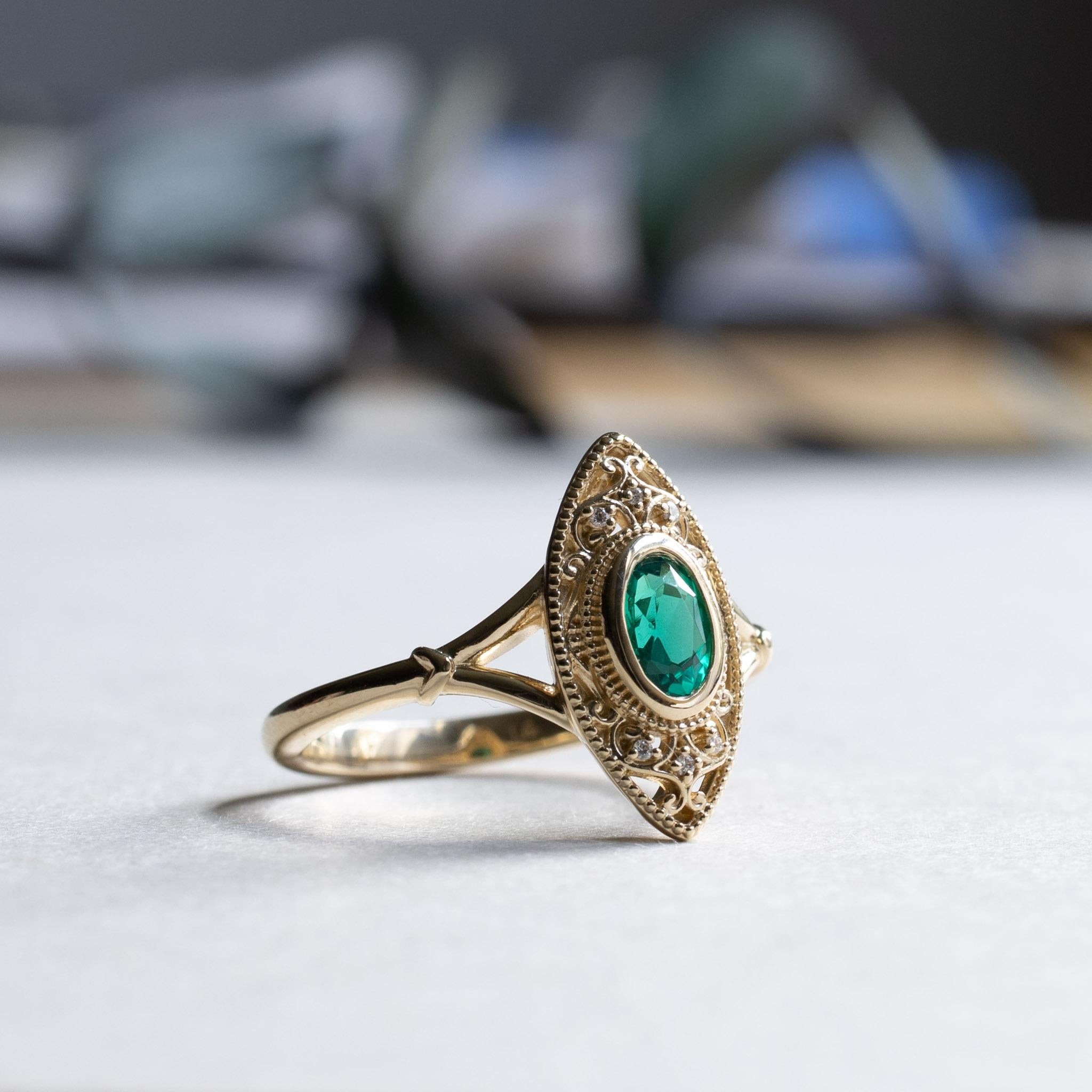 Oval emerald stone bezel with diamonds set on 14k yellow gold.
Stone Shape: Oval
Stone Type: Lab-created emerald
Metal Type: 14 Karat Yellow Gold
Stone size: 4mm x 6mm
Band width: 1.7mm
Accent Stones: Lab Diamonds
Lab Diamond Clarity: SI1-SI2
Lab