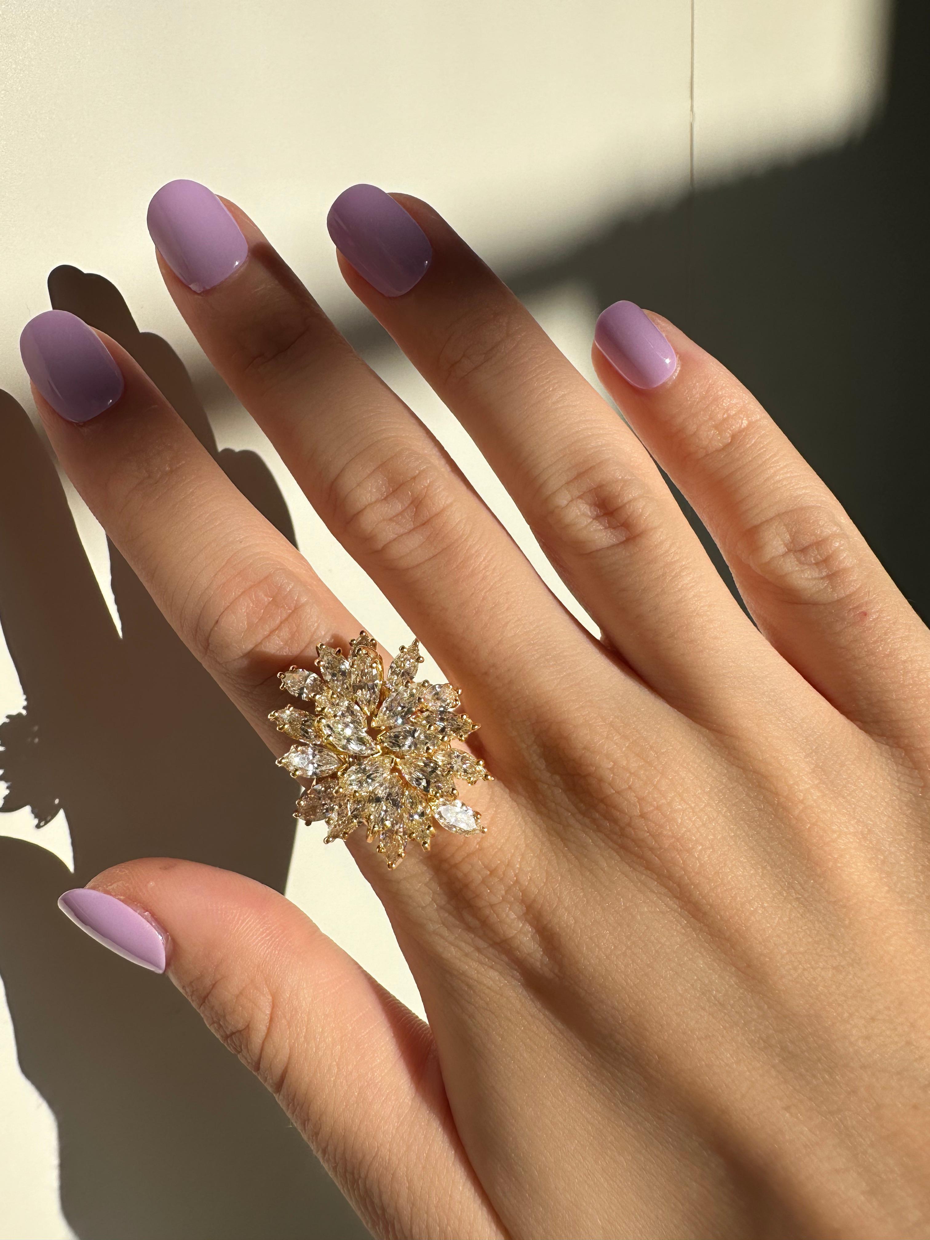 Bold and glamorous, this 14K yellow gold cocktail ring showcases an eye-catching 5.50 carats of marquise cut diamonds. Measuring 1.10 inches wide and rising 11.70mm above the finger, it makes a confident statement with vintage flair. In good
