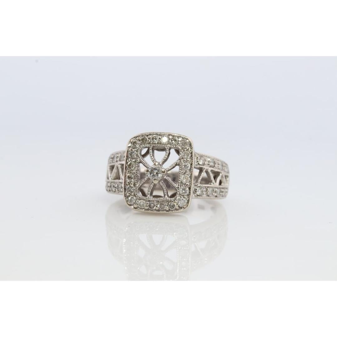 Vintage from the 1950s
Materials: Gold
Gemstone: Diamond
Gem color: Colorless
Band color: Gold
Style: Art deco
Very beautiful diamond ring. Filigree open design shield with a center diamond set in a square setting.

Condition: Shows little signs of