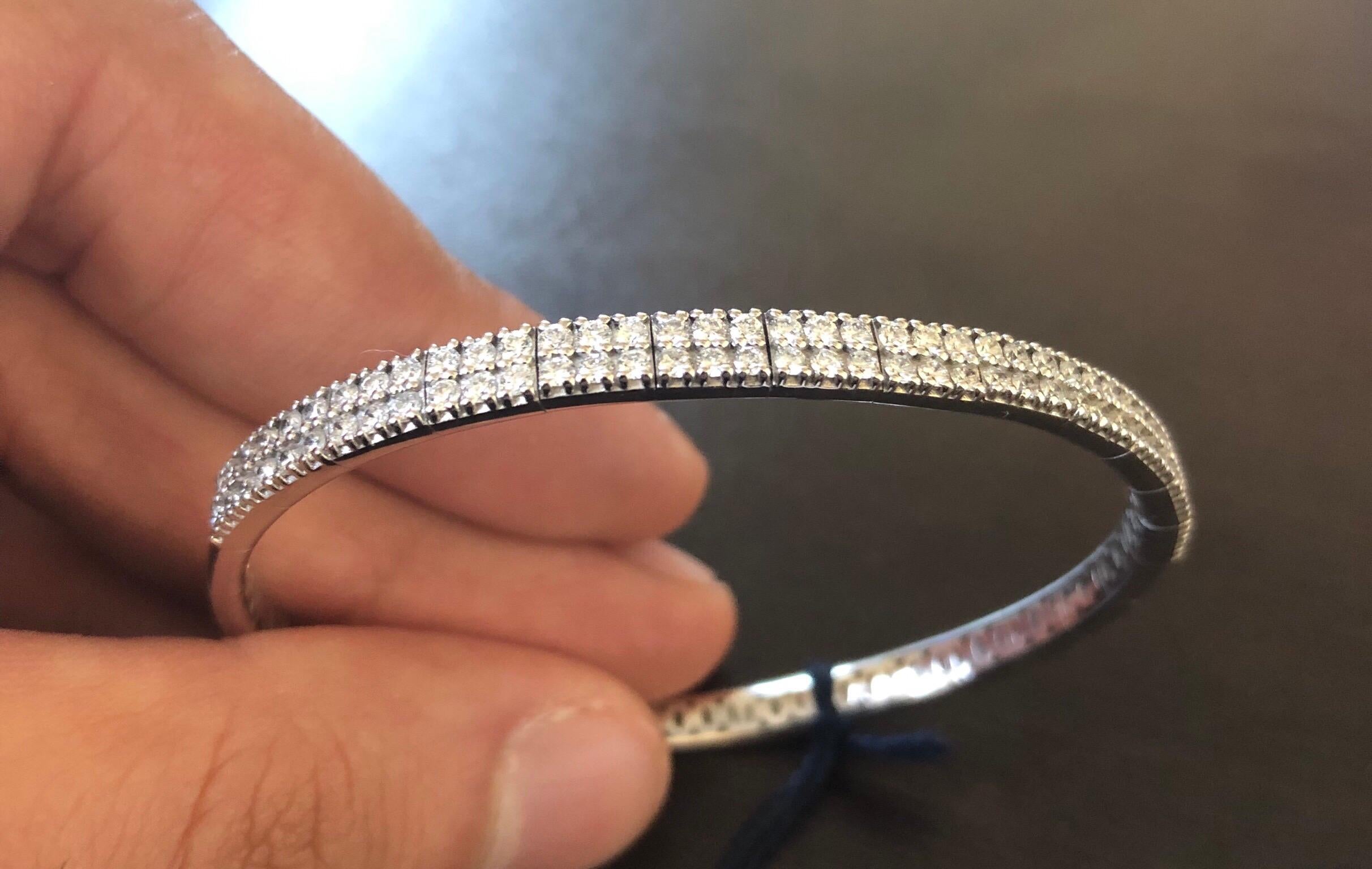 Italian diamond bangle flexible set in 14K white gold. The bangle is set with 2 rows of diamonds half-way. The total diamond weight is 1.56 carats. The color of the stones are F-G, the clarity is VS1-VS2.
