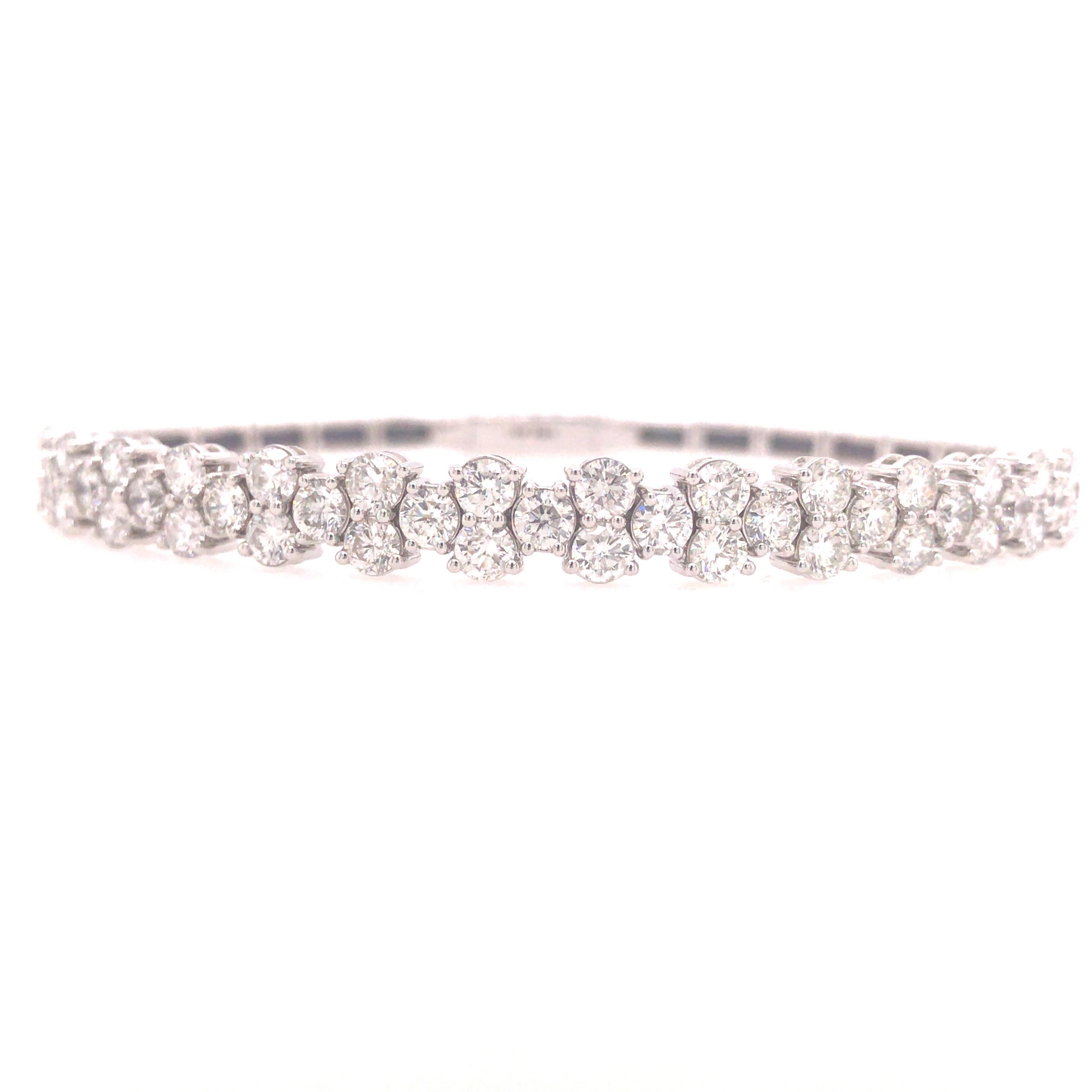 Flexible Diamond Bangle in 14K White Gold.  Round Brilliant Cut Diamonds weighing 3.90 carat total weight, G-H in color and VS in clarity are expertly set.  The Bracelet measures 6 1/2 inches and 1/4 inch in width at the widest point.  Lock closure.