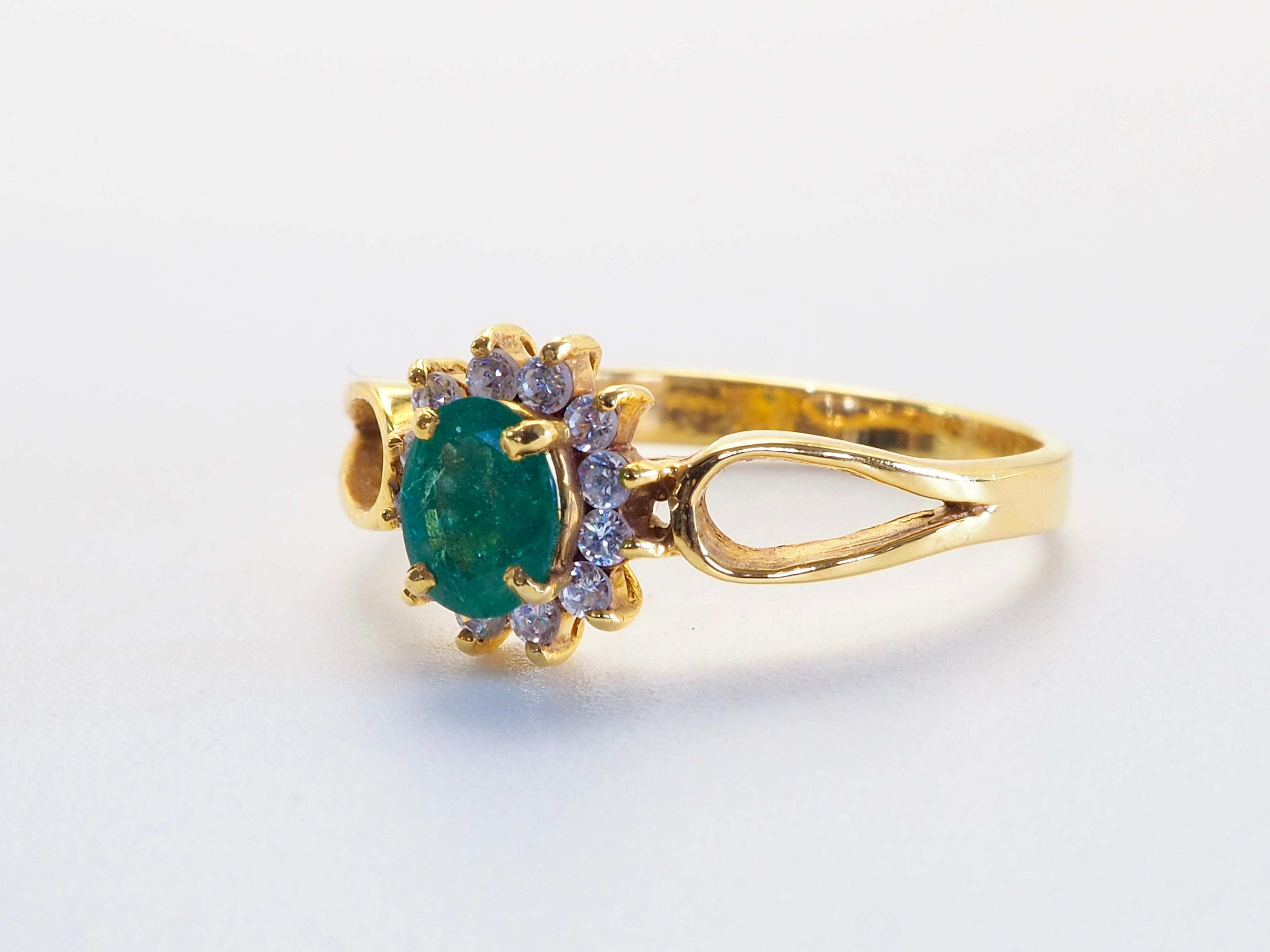 Classic design ring equipped with a wonderful green oval emerald with natural jardins and surrounded by brilliantly decent grade white quartz. For those who have a soft spot for pretty emeralds and for unassuming easy luxury wear.

Product