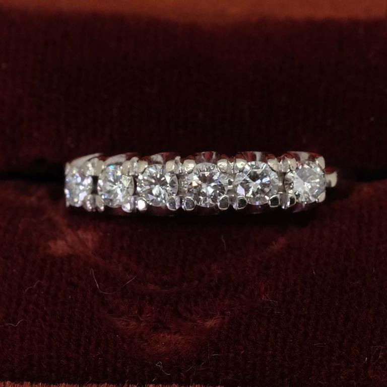 One-ladies 14K gold ring with 6 x round brilliant cut diamonds.  Estimated brilliant weight 0.75 ct. Ring size 5