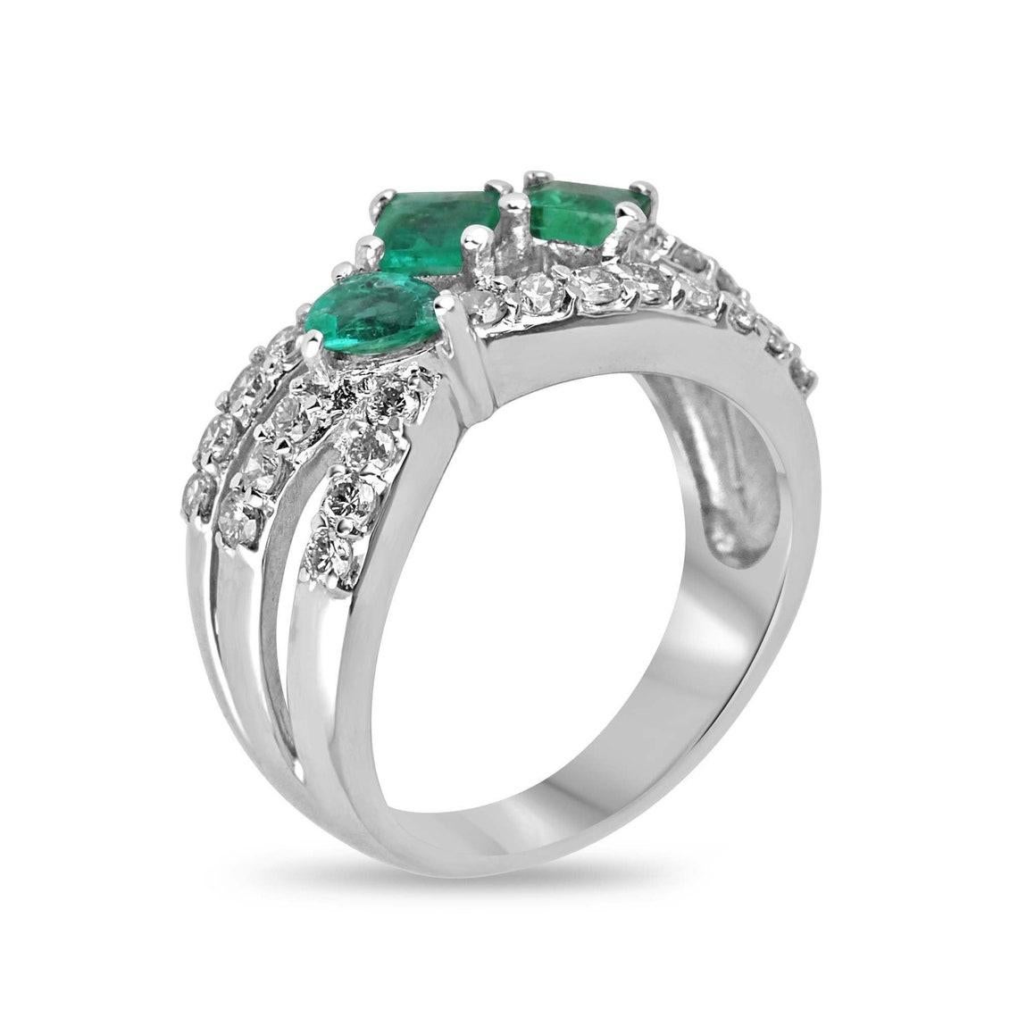Elevate your style with our exquisite Emerald and Diamond Accent Ring, a true embodiment of sophistication and elegance. Featuring three petite emeralds, including two princess-cut gems and a pear-cut centerpiece subtly off the axis, this ring