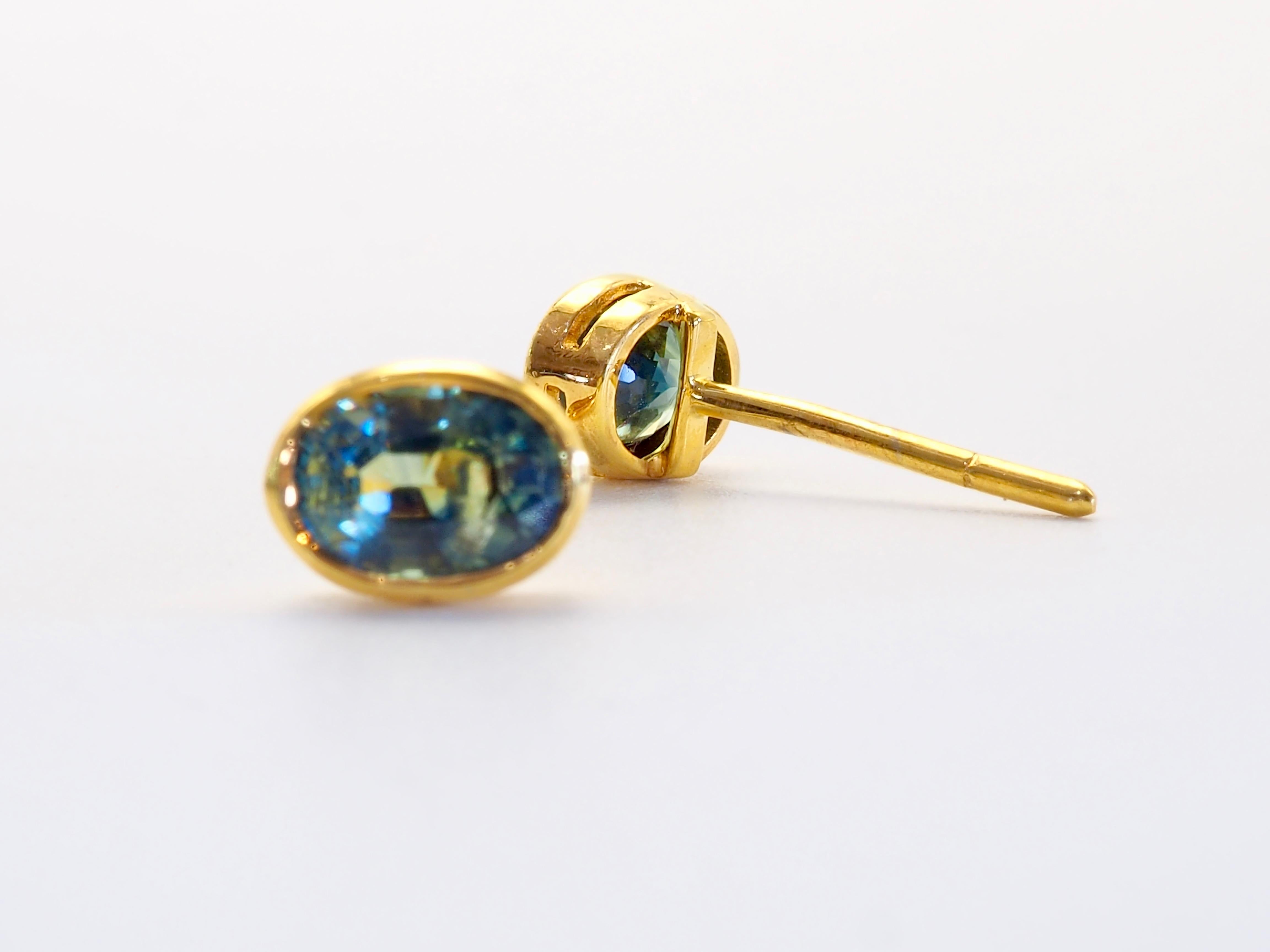 Teal green sapphires are gaining more followers year after year for its unique play of color. These twins are especially clear and unique with some yellowish tint. Strong and clean bezel set- Perfect for wearing every day. September