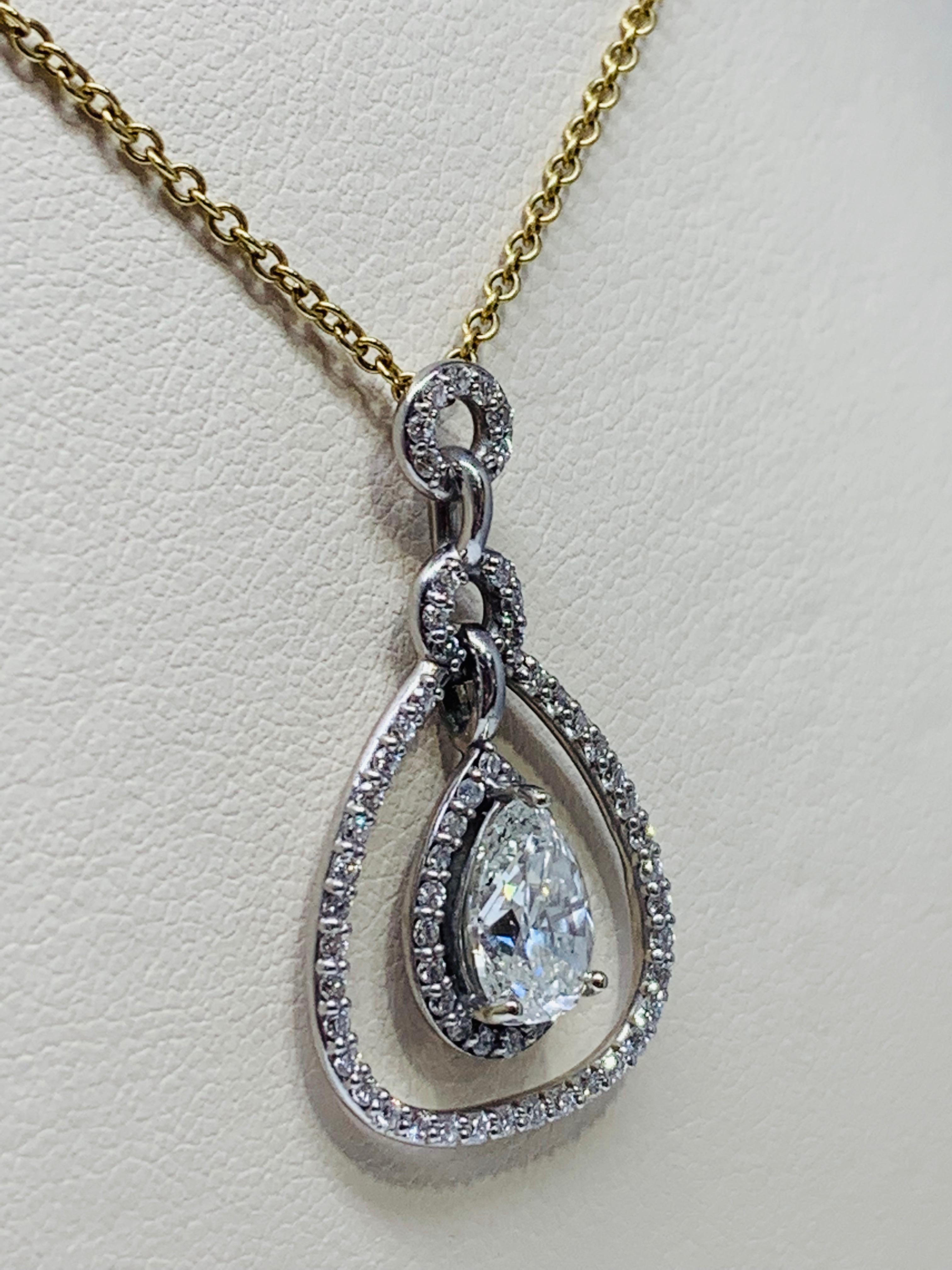 This gorgeous 1.93 carat diamond pendant features a double-halo like design. The pendant itself is set in white gold and includes an 18 inch yellow gold cable chain. The chain can be switched for a 14K white gold cable chain upon request. The center