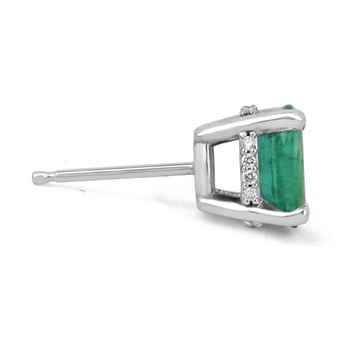 Featured here is a stunning set of oval emerald studs in fine 14K white gold with sparkling diamond accents along the sides. Displayed are rich medium-green emeralds with very good clean transparency, accented by natural diamonds in gold earring