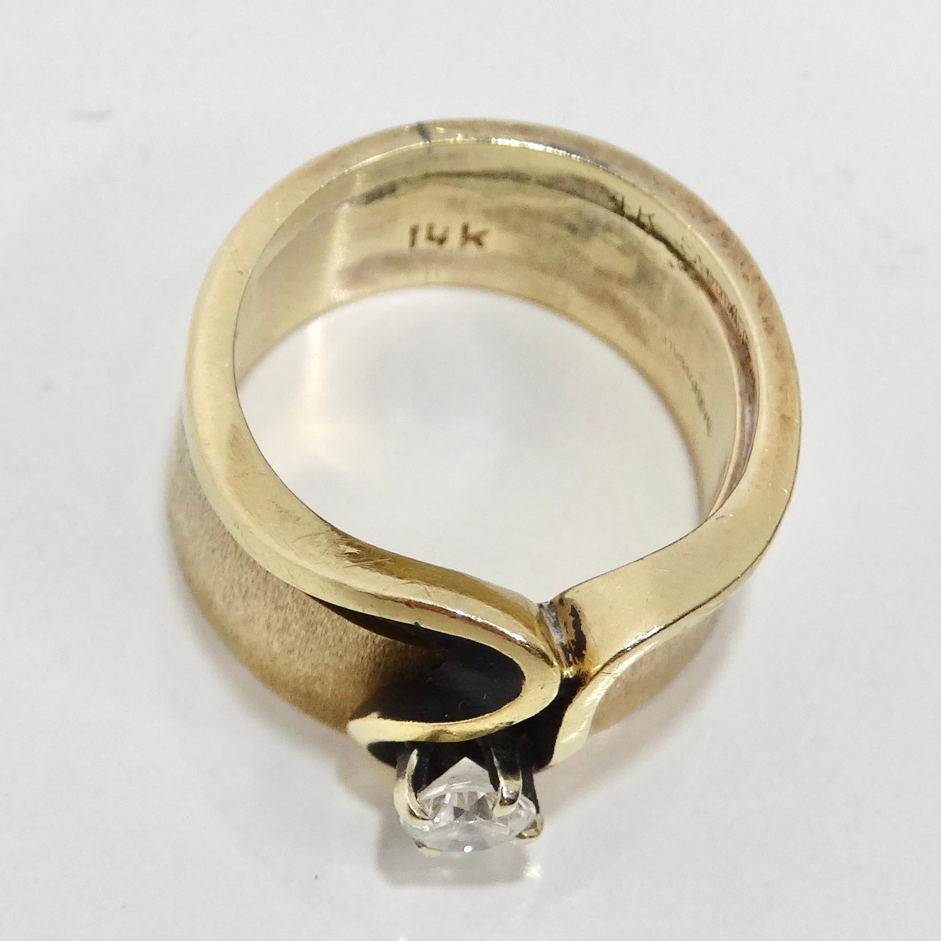 Elevate your style with the 14K Gold 1960s Diamond Ring, a classic and luxurious ring that encapsulates the beauty of the 1960s with an abstract wave engraving and a stunning 0.25 carat round clear diamond. The thick band ring in 14k yellow gold is