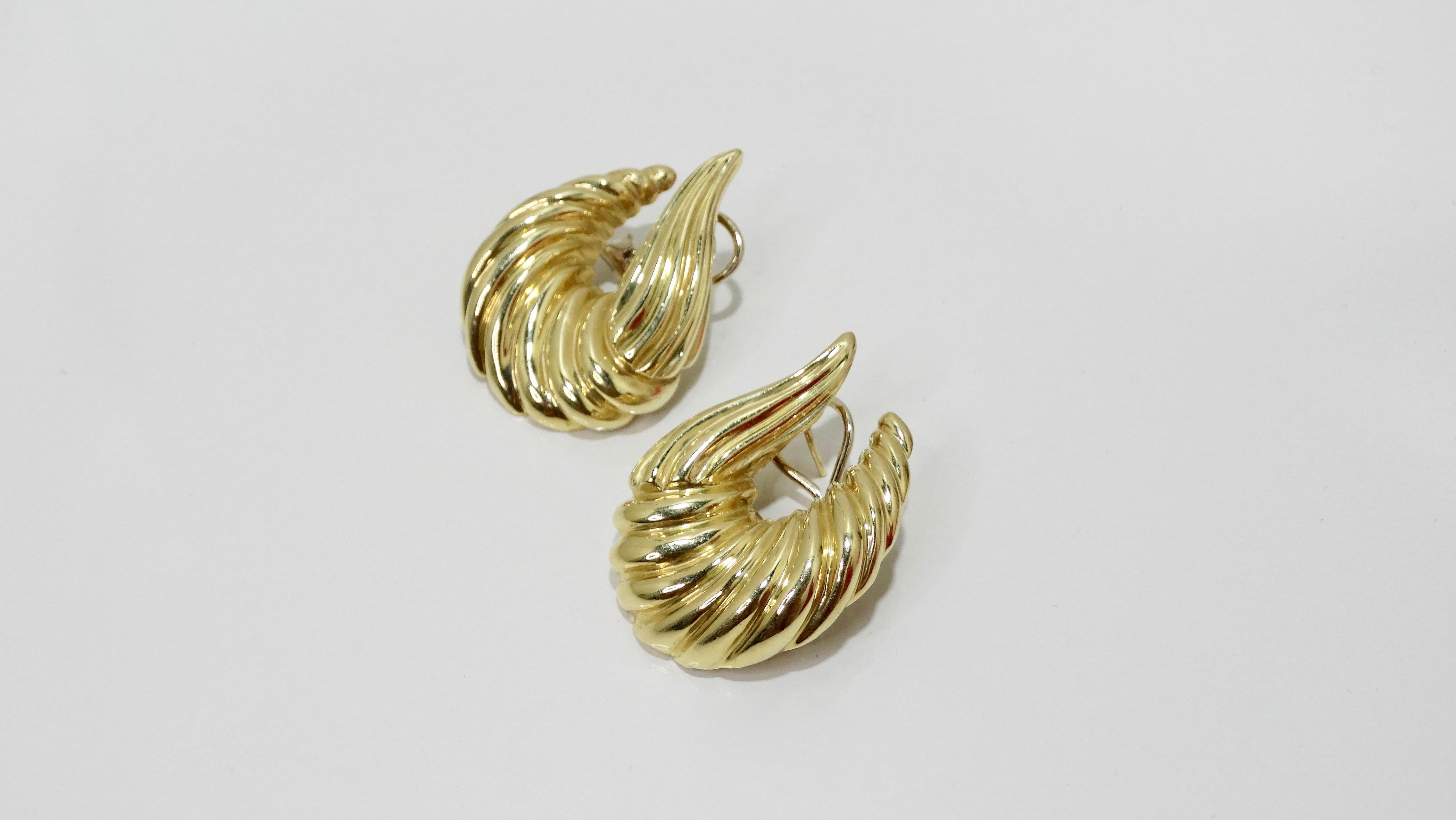Complete your collection with these stunning earrings! Circa 1970s, these shrimp style earrings are crafted from shiny 14k gold and feature an asymmetrical ribbed design. Earrings have pierced lever back closure for a secure wear. Total weight is