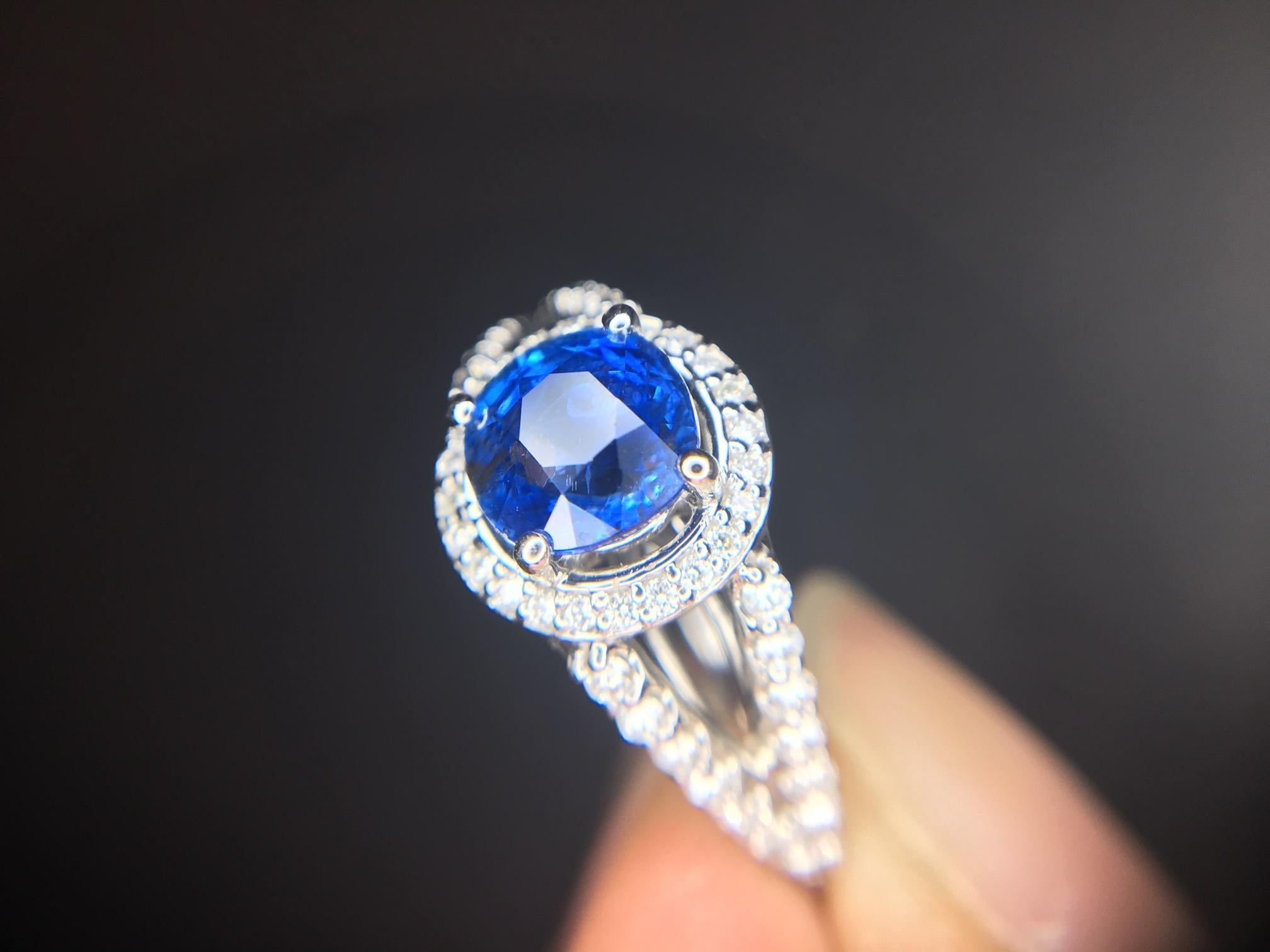 14k Gold 2 Carat Blue Genuine Natural Sapphire and Diamond Halo Ring (#J3800)

14k white gold ring featuring a very fine round blue sapphire weighing 1.53 carats. The sapphire has velvety royal blue color and measures 6.3mm. The sapphire is accented