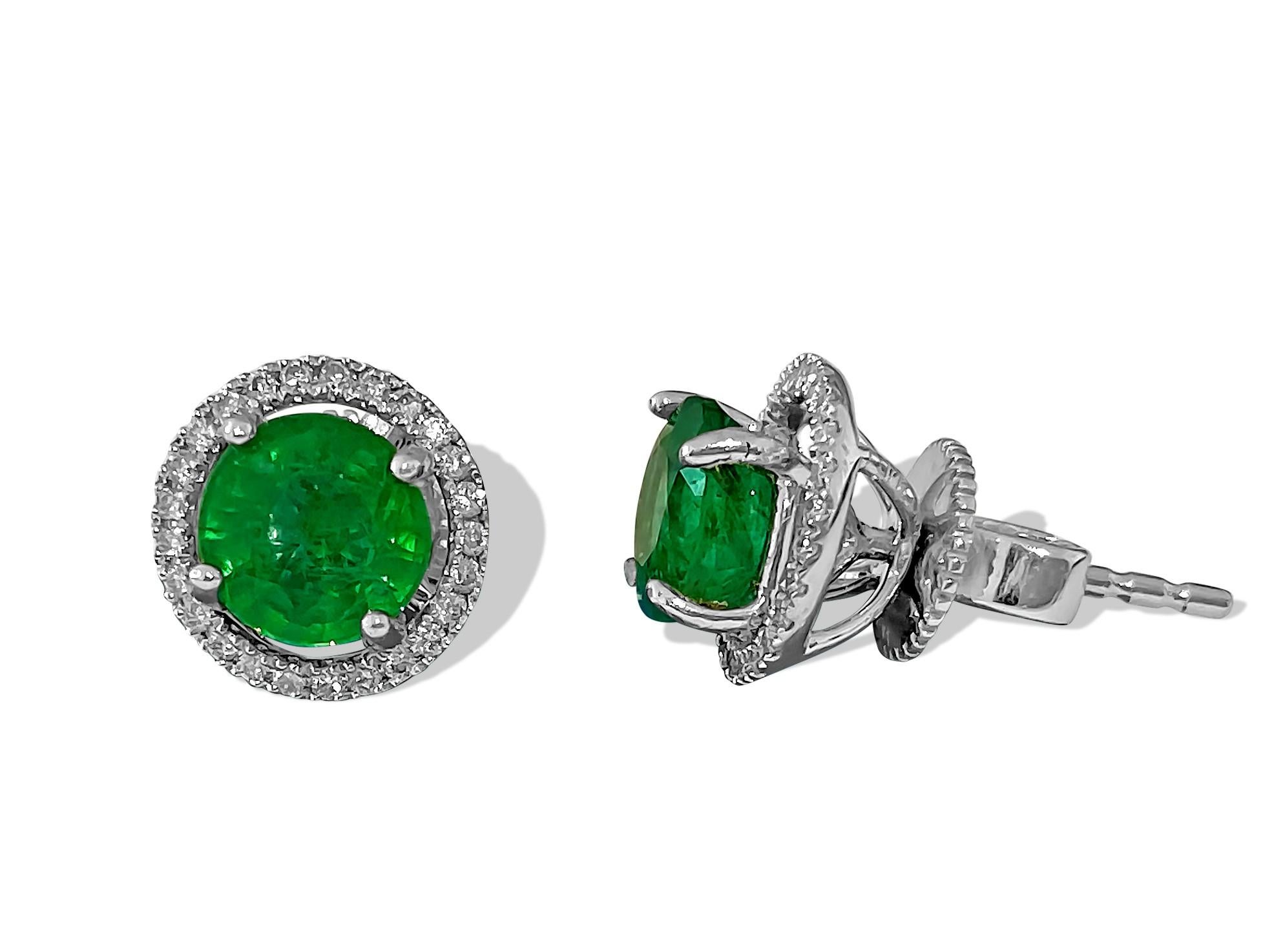 Elegant and timeless, these sublime earrings crafted in 14k white gold feature 0.50 carats of G color, VS clarity diamonds, and 2.00 carats of round-shaped, natural earth-mined emeralds. Perfect for special occasions, these stunning earrings