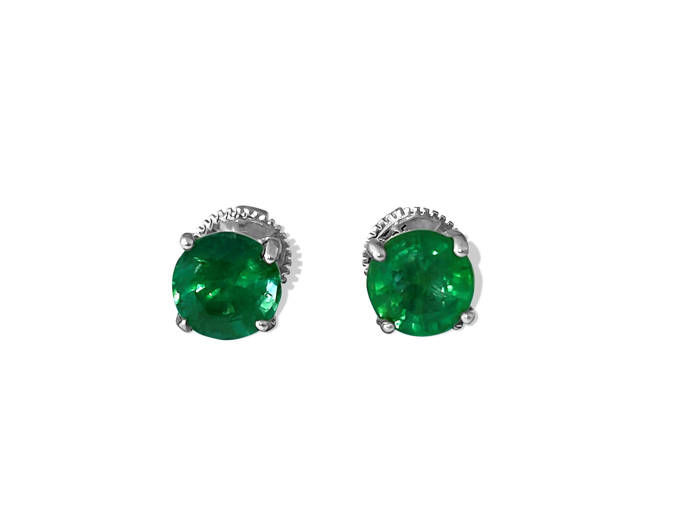 Elegant and timeless, these sublime earrings crafted in 14k white gold feature 0.50 carats of G color, VS clarity diamonds, and 2.00 carats of round-shaped, natural earth-mined emeralds. Perfect for special occasions, these stunning earrings