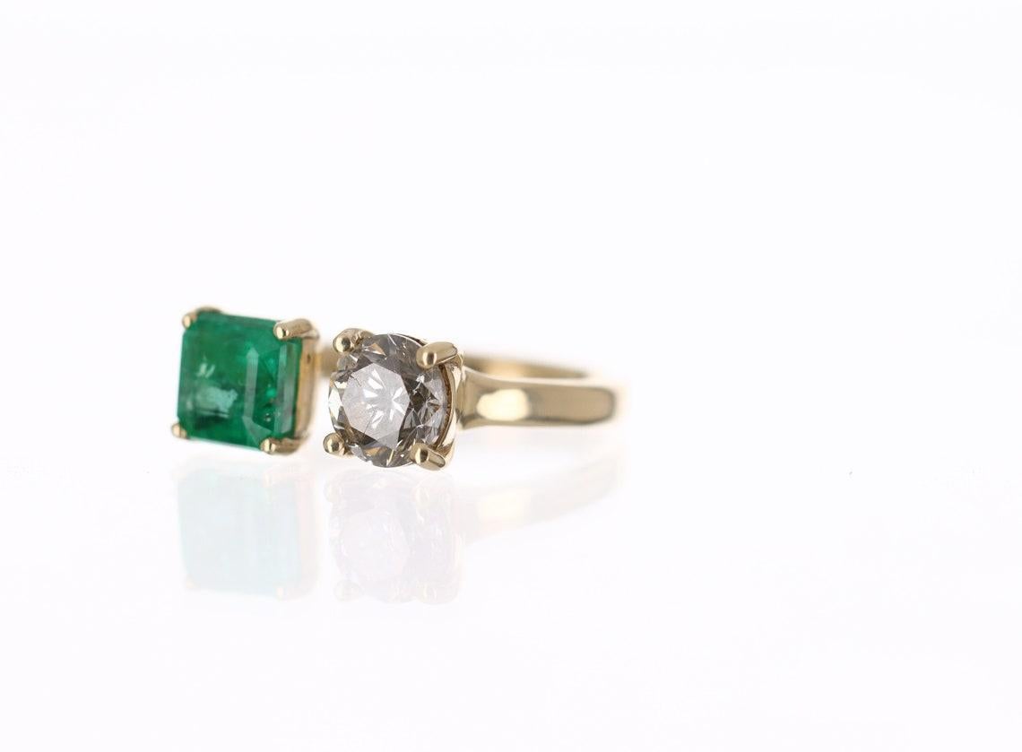 This is a stunning 14K yellow gold, emerald, and round diamond statement ring or right-hand 2-stone ring. 