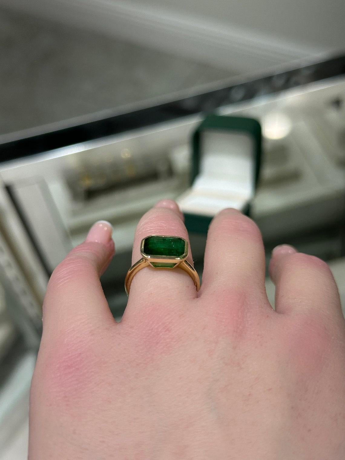 14K Gold 2.90cts Bezel Set Emerald Solitaire Ring, East-West Emerald Cut Design In New Condition In Jupiter, FL