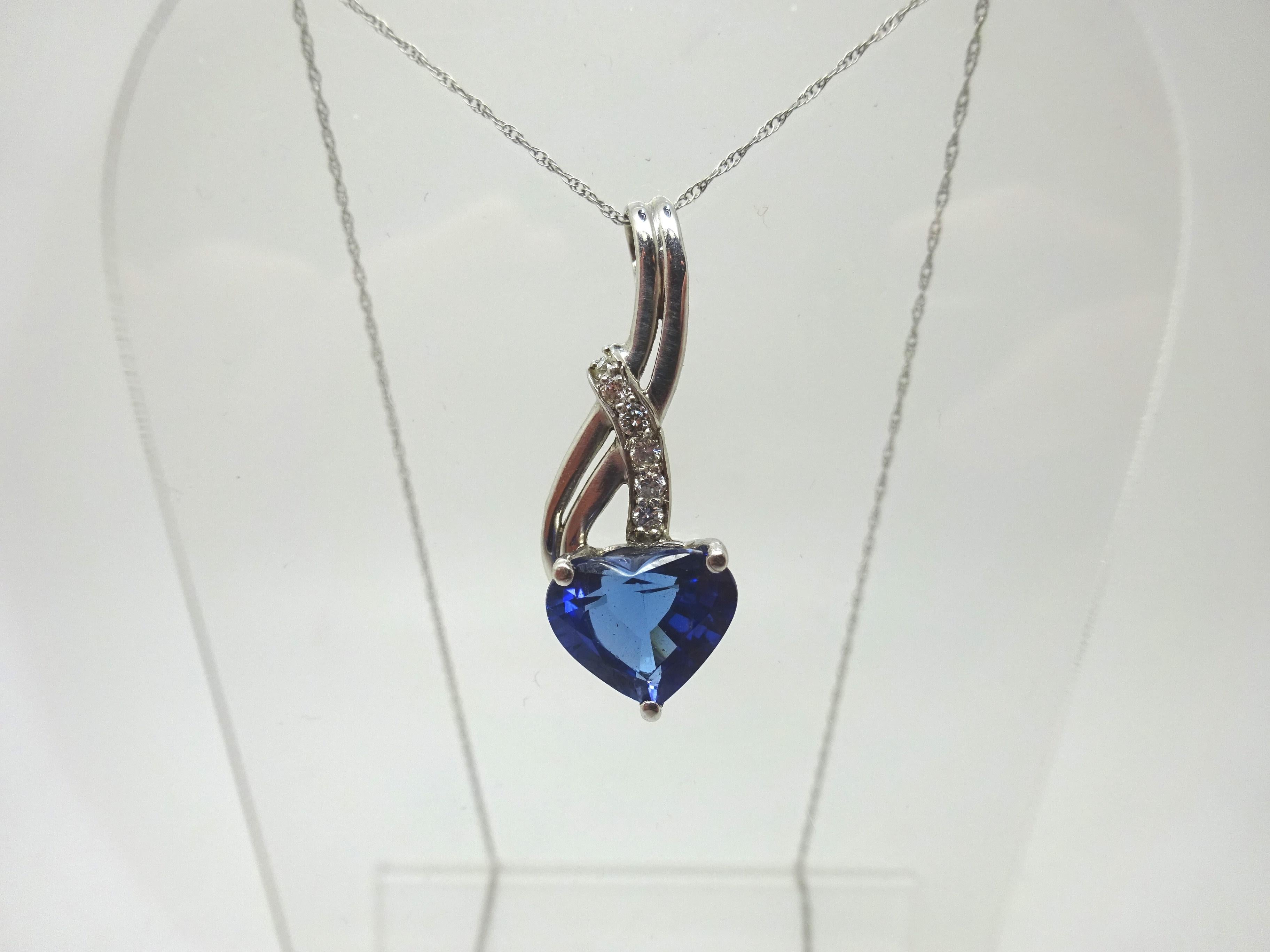 Radiant 14k white gold necklace with a 3.10ct tanzanite in a shape of a heart with a brilliant blue color. The tanzanite measures 9x10mm. The pendant also has six dazzling diamonds that are 2mm. The length of the chain is 18 3/4