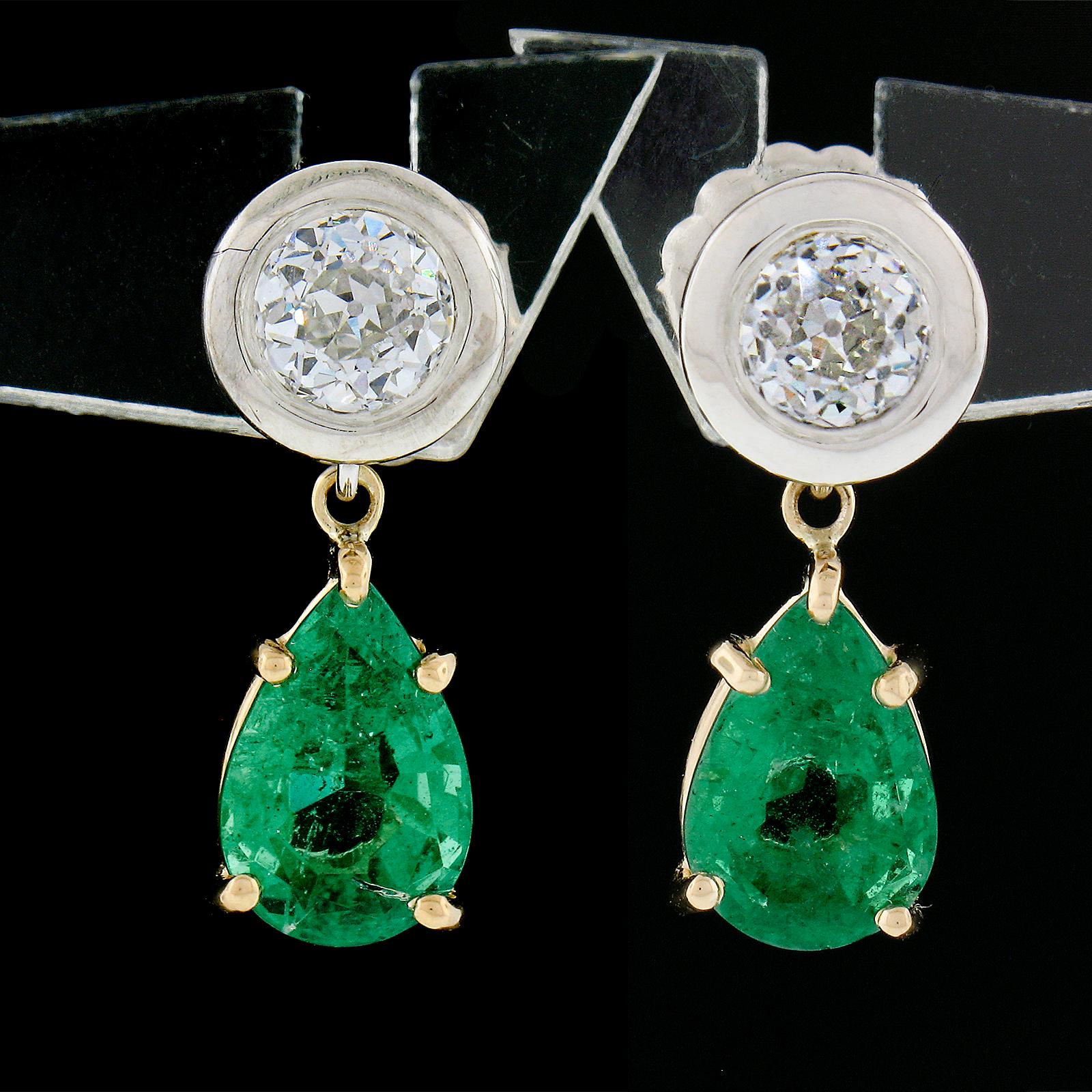 These magnificent brand new earrings were crafted in solid 14k gold and feature old stones with a matching pair of GIA certified pear brilliant cut emeralds prong set in sturdy yellow gold baskets. The emerald stones are a truly breathtaking, super