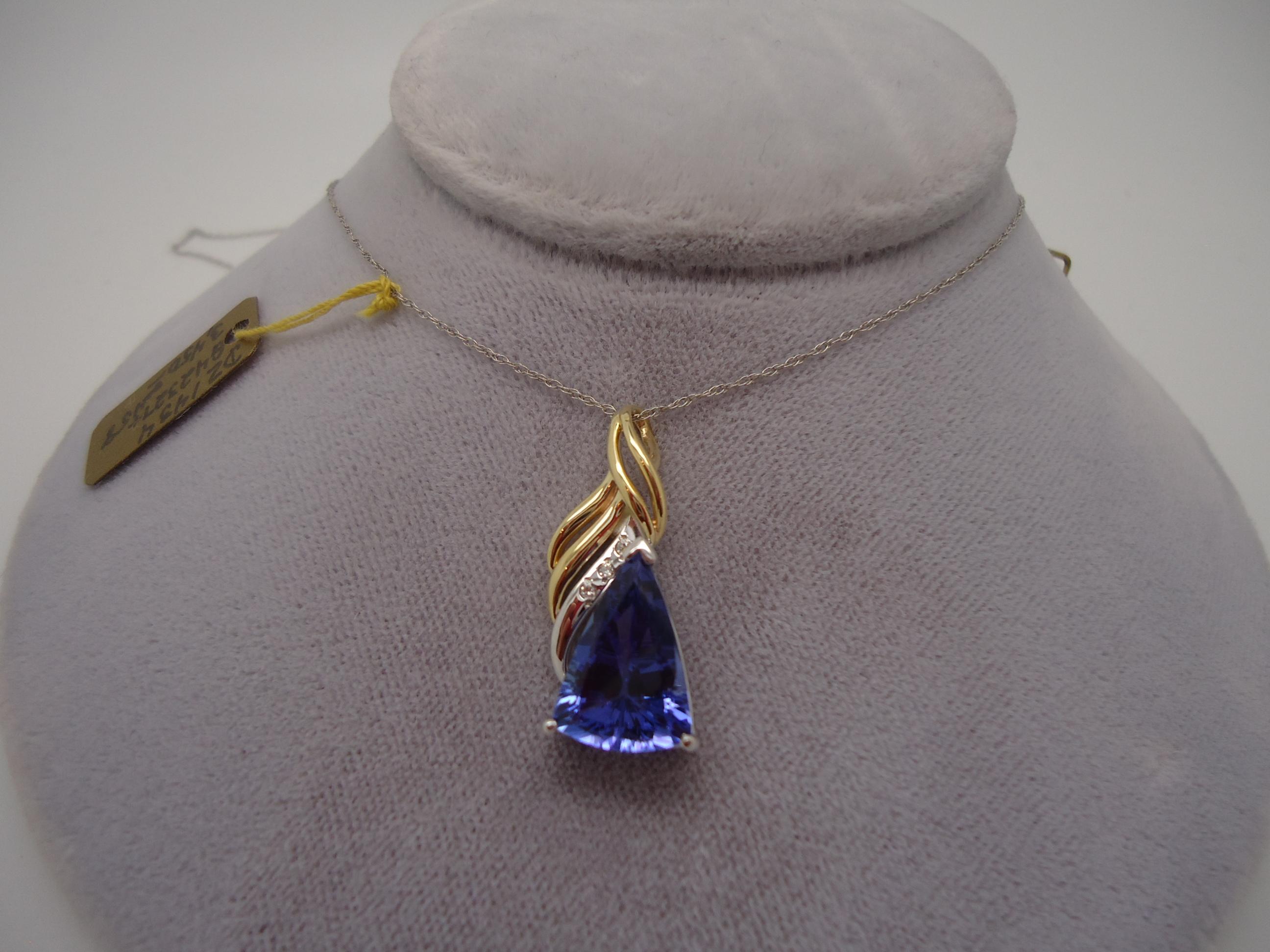 14k Gold 3.47ct Trillion Genuine Natural Tanzanite Pendant with Diamonds (#718)

14k white and gold necklace with a 3.47ct trillion shape tanzanite which measures 14x9mm. The necklace also has small diamonds that are 1mm. The tanzanite has an eye