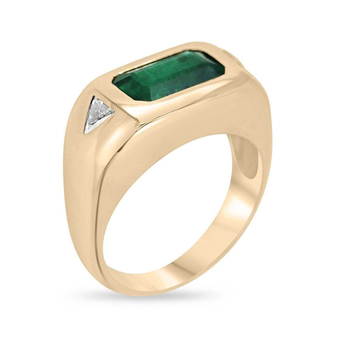 Elevate your elegance with our exquisite Emerald and Diamond Three-Stone Ring, featuring a captivating Zambian emerald at its heart. This emerald's deep, forest green hue and semi-transparent clarity, coupled with its very good luster, create a