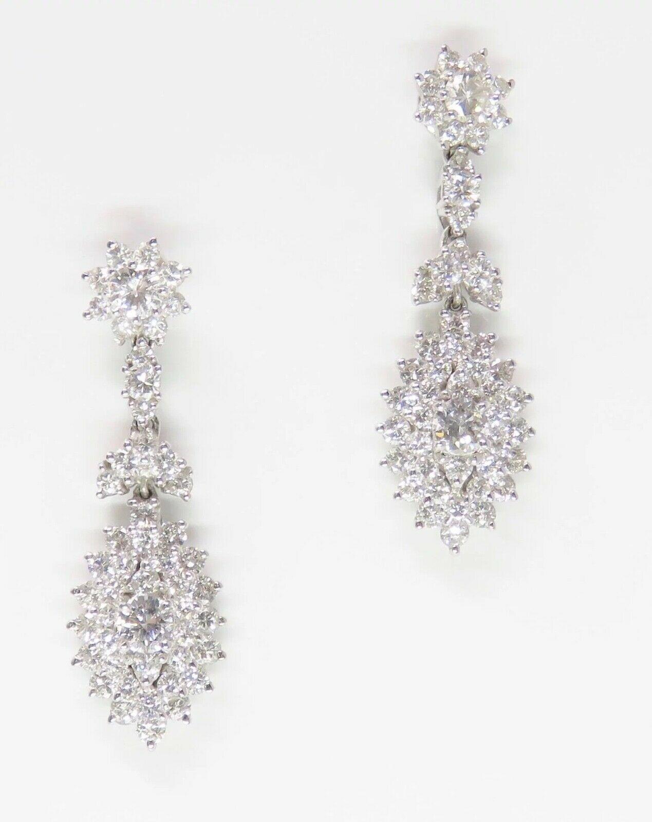 Impressive 14k Gold 4.00 Carat F VS Diamond Dangle Drop Pendant Earrings

These stunning earrings are set with a total of 100 diamonds (tested and are natural), totaling approximately 4.00 carats total weight. The 4 center diamonds are approximately