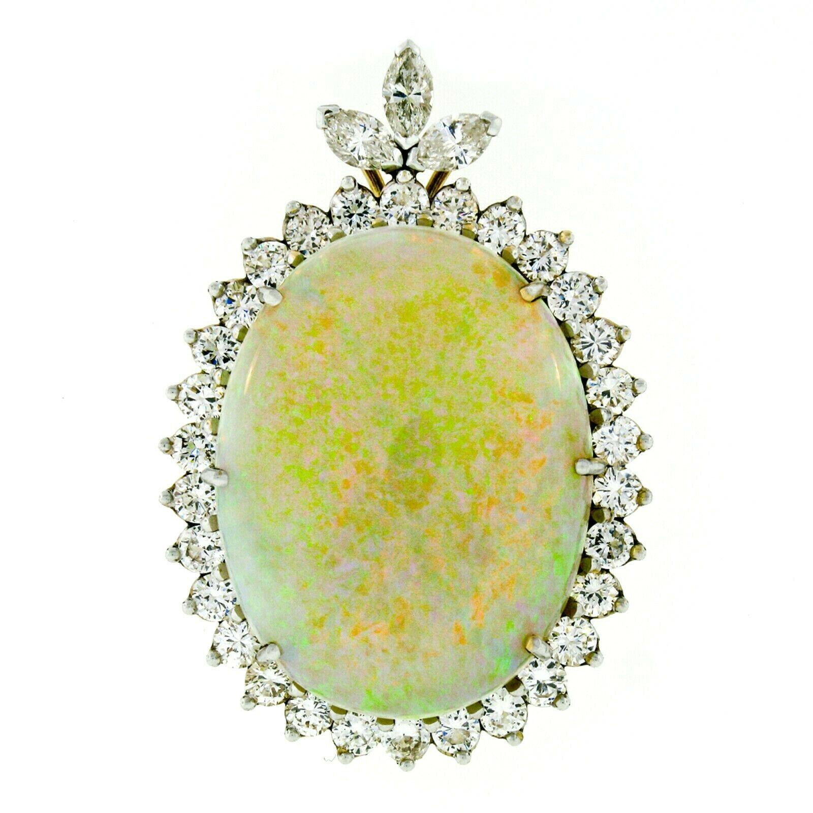 You are looking at a jaw-dropping piece that is hand crafted in solid 14k yellow gold and features a large slide pendant which is set with a very fine quality opal of unusually large size with a magnificent diamond frame. The opal has been GIA