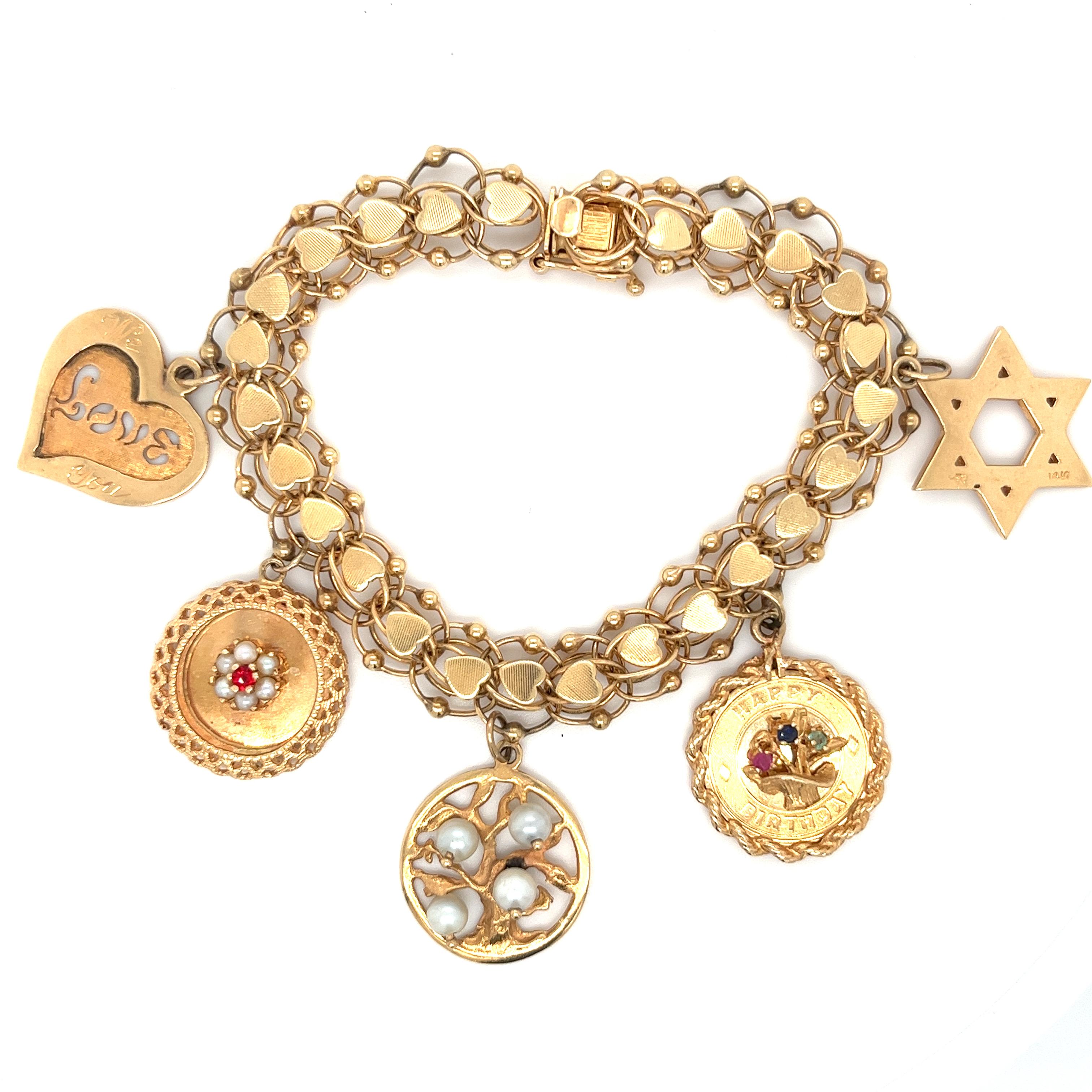 Introducing this extremely detailed 14k gold charm bracelet. Each link has two cable links interlocked together to the preceding link and is topped with a gold heart. A truly beautiful vintage estate piece made to tell that special someone how much