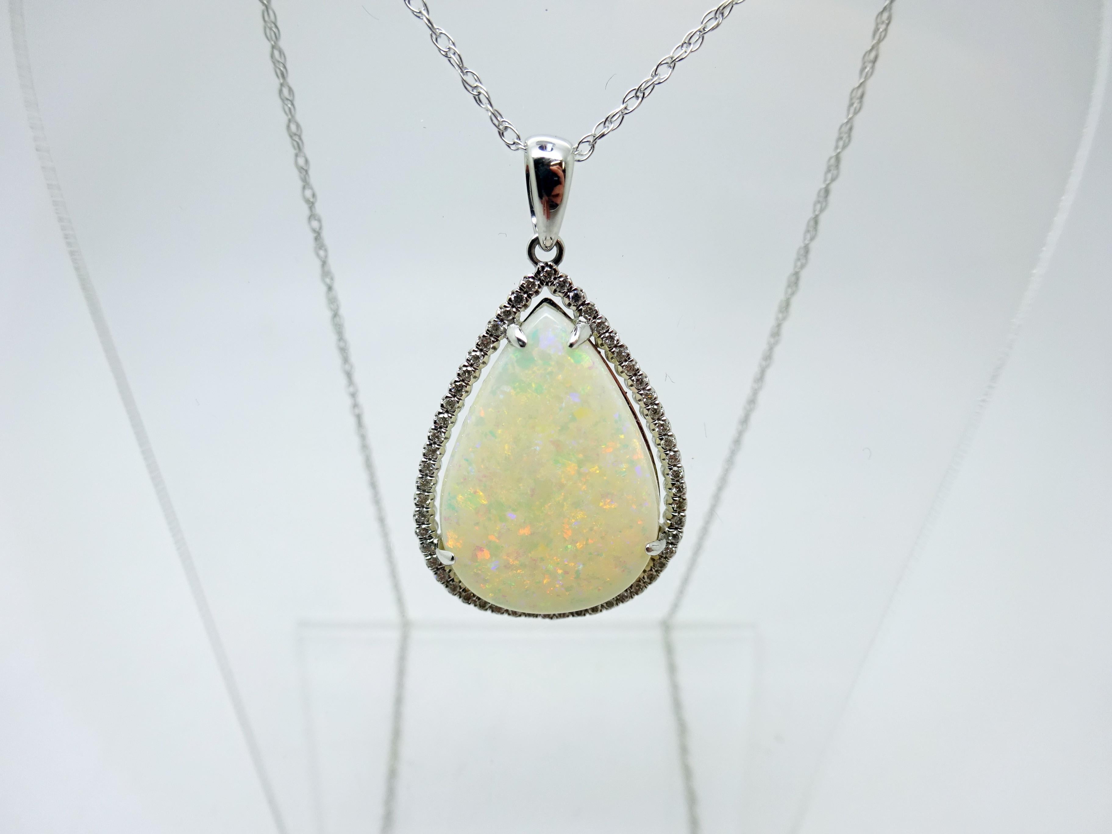 14k Gold 5.67ct Pear Genuine Natural Opal Pendant with .16ct Diamonds (#3427)

Majestic 14k white gold opal and diamond pendant. The piece features a large beautiful pear shaped opal that weighs approximately 5.67 carats, with small round diamond