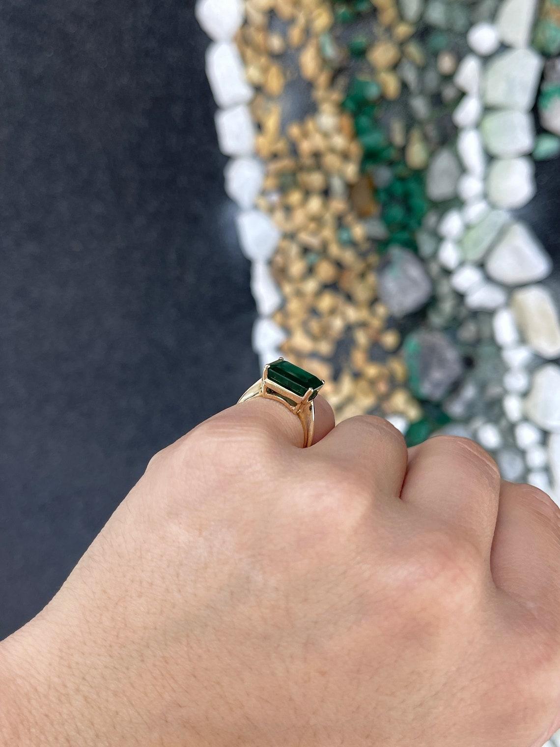Women's 14K Gold 6.28ct Dark Green Emerald Cut Solitaire Ring, East-West Prong Set For Sale