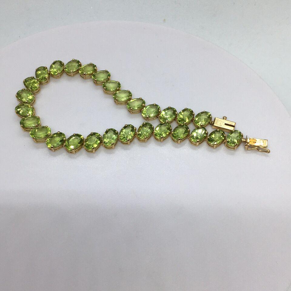 14K gold 7 mm by 5 mm 28 Oval Natural Peridot Tennis Bracelet Women 7.25 inch




28 stones, 7 mm by 5 mm, oval cut Natural Peridot 
7.25 inch long
Weighting 10 gram
14k stamped tested
In good condition, no evidence of repairs, see pictures