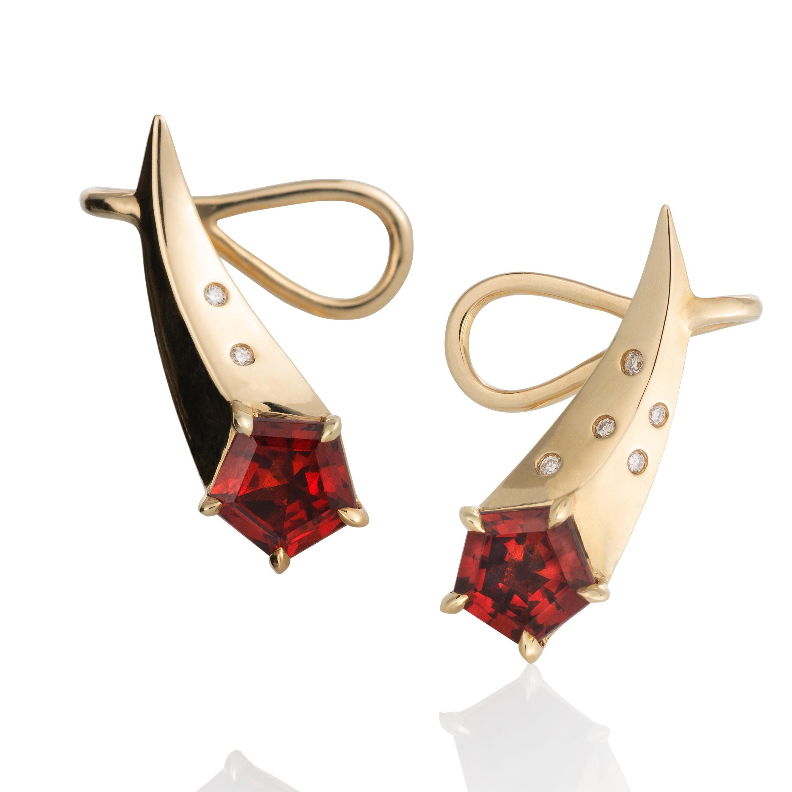 Made in 14ky with diamonds, these are perfect little ear climber earrings, designed for daily wear.  They are small, shooting stars with fancy cut, 5mm Madeira Garnet and ten tiny diamonds lighting up the tail of the comet.

The earrings are made