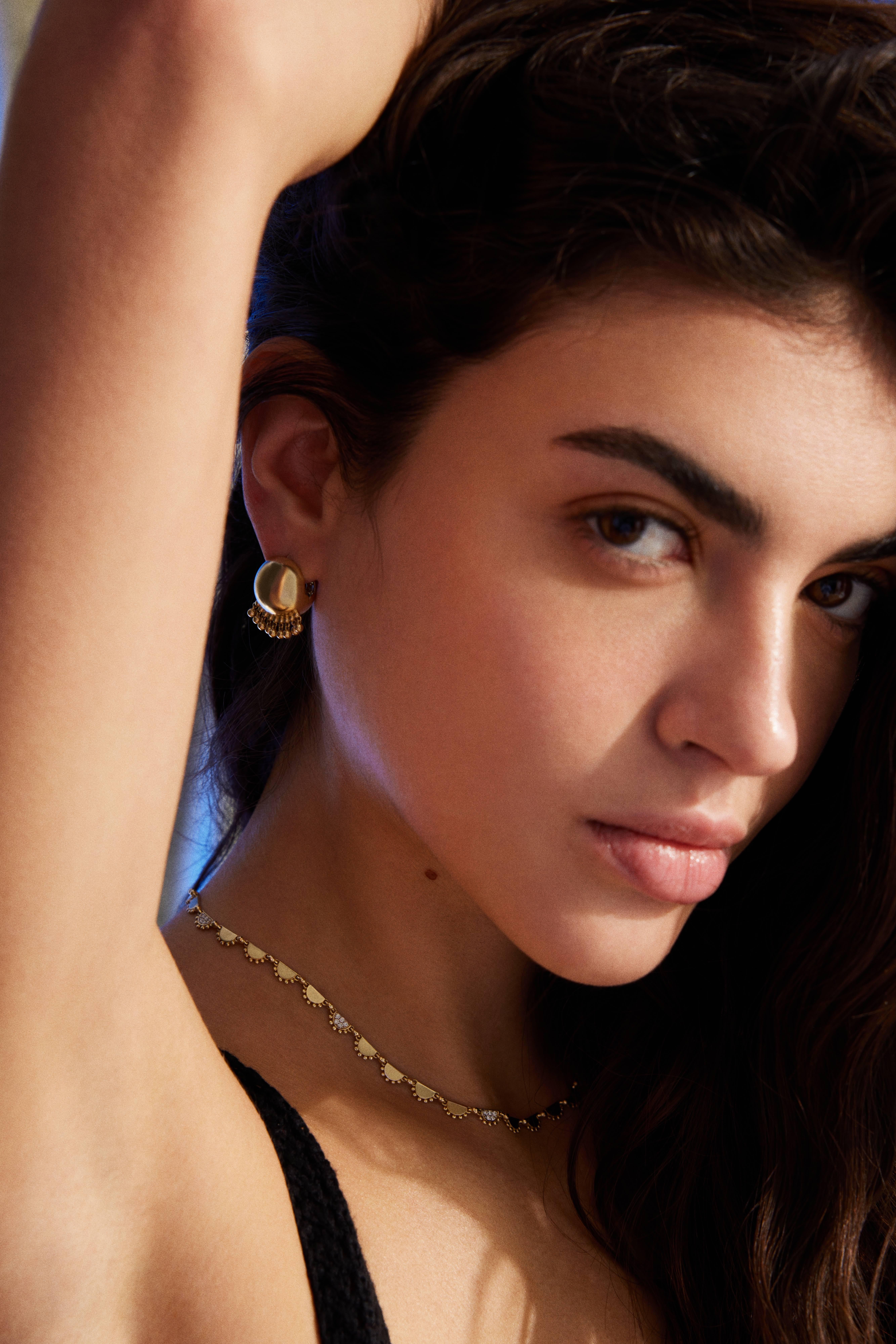 Collana in stile boho in oro 14 carati e  ornata di diamanti.