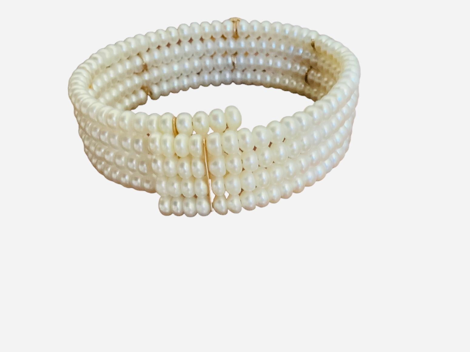 This is a set of 14K yellow and white gold pearls cuff bracelet and choker necklace. Both of them depicts four rows of round pearls very well mounted in stretching wire like, so they can easily open and close. In the center, each of them are