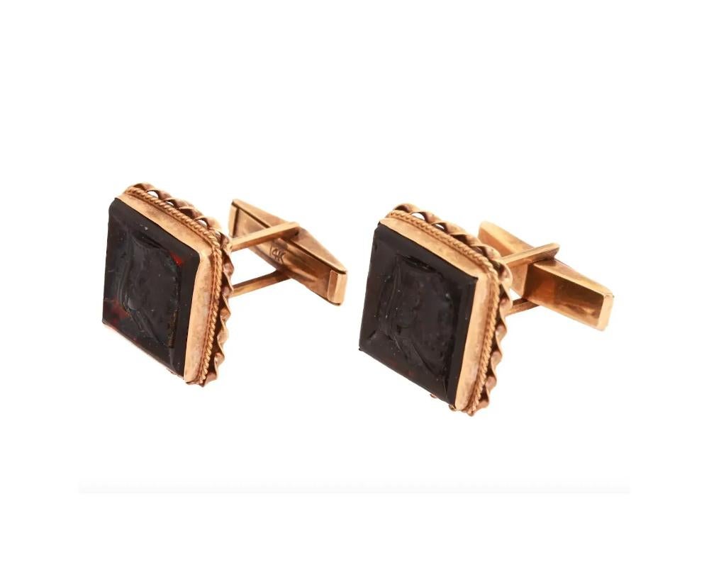 A pair of vintage 14K gold cufflinks with bullet back. The cufflinks are set with cherry red cameo glass with a cut relief representing a female profile portrait in Ancient Roman style. Hallmark 14K is on the backing of the pieces. Weight: 13.3
