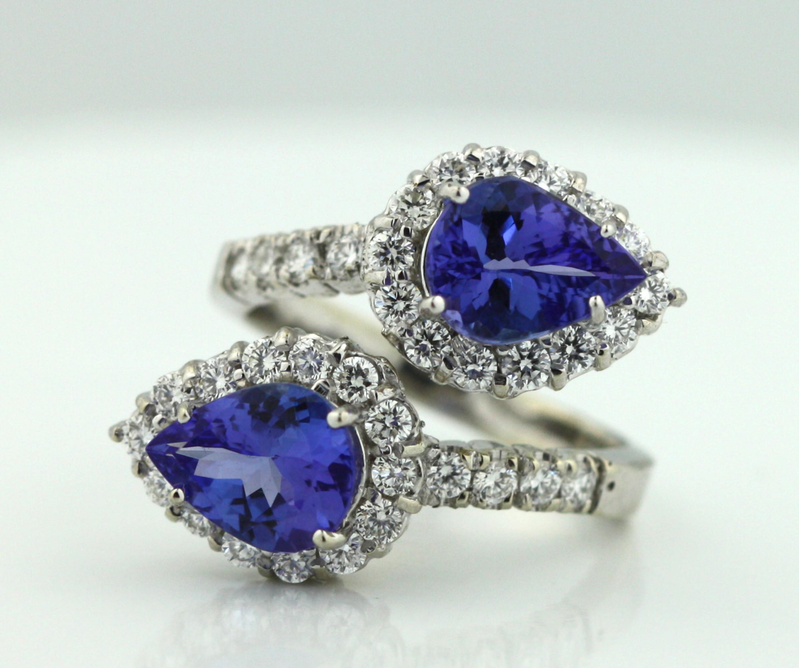 
14K Gold and Tanzanite and Diamond Ring 
Featuring two pear-shaped Tanzanites, weighing approximately 2.98 carats, measuring approximately 9 x 7 mm within a surround of thirty-six round, brilliant-cut diamonds weighing approximately 0.96 carats