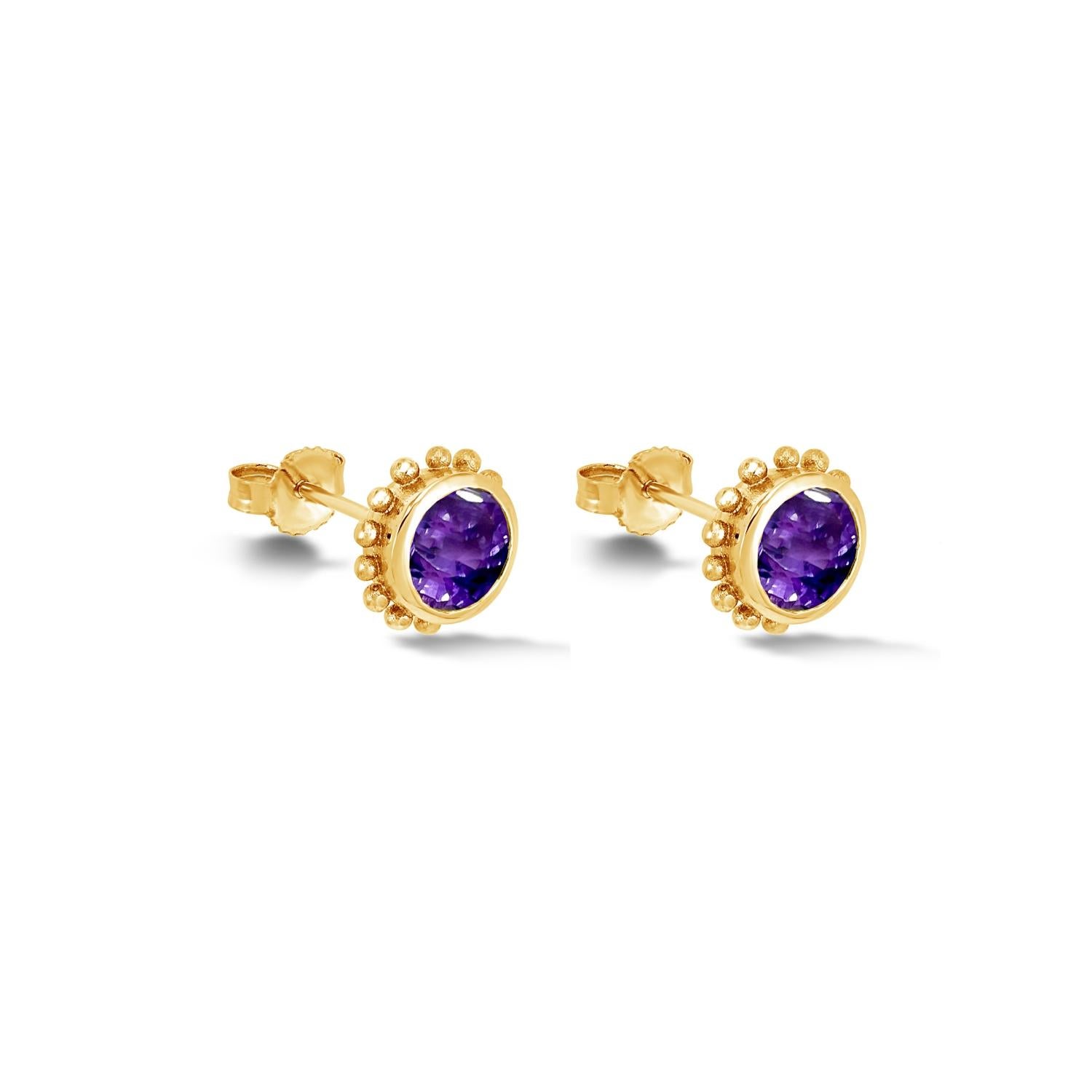 These elegant amethyst stud earrings are made in solid 14k yellow gold and feature granulated spheres around the outside of the rub-over setting. Inspired by creatures of the coral reef, the Anemone collection is fascinating in its