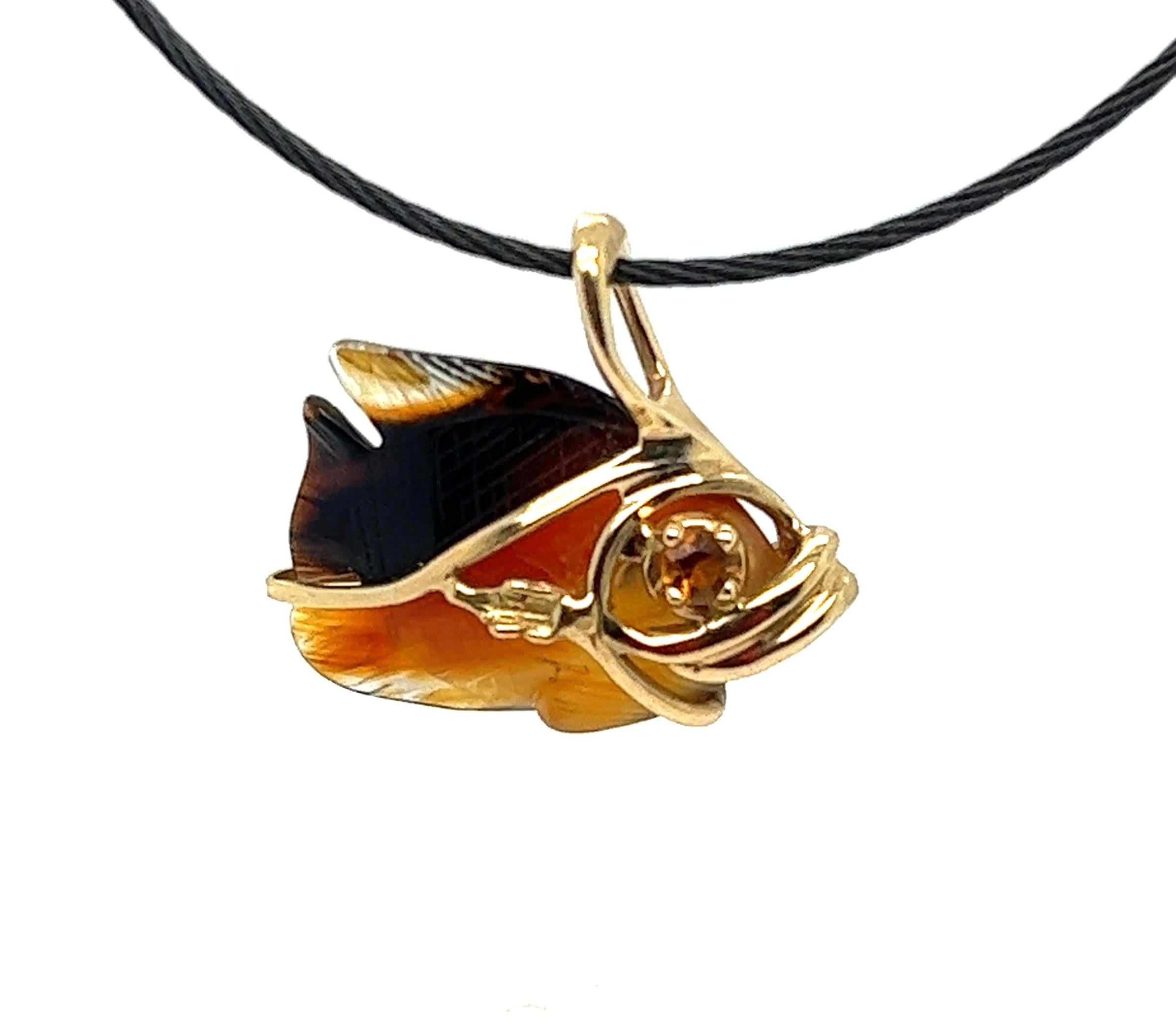 Offered here is a one of a kind sculpted angelfish in 14 karat yellow gold frame with citrine eye and smokey quarts body.
Pendant is hanging on a black marine cord with 14 kt yellow gold ends and lobster claw.
Pendant is 25mm by 15mm high, bale not