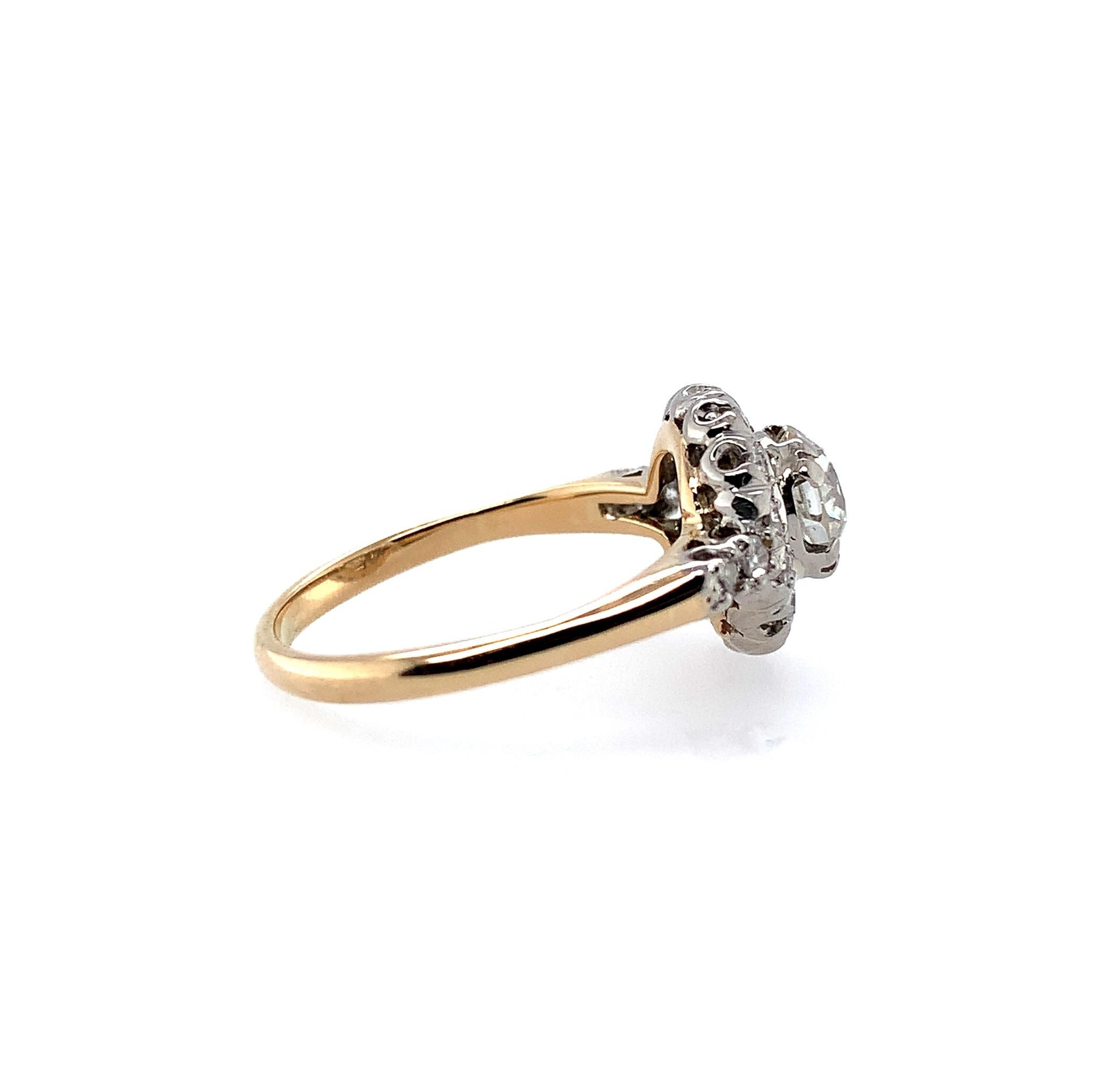 14k yellow gold antique diamond ring with about 1.15 carats total weight of antique diamonds set in a white gold top. The center European cut diamond measures about 5.98mm and weighs about .91cts. The 18 surrounding single cut diamonds measure about