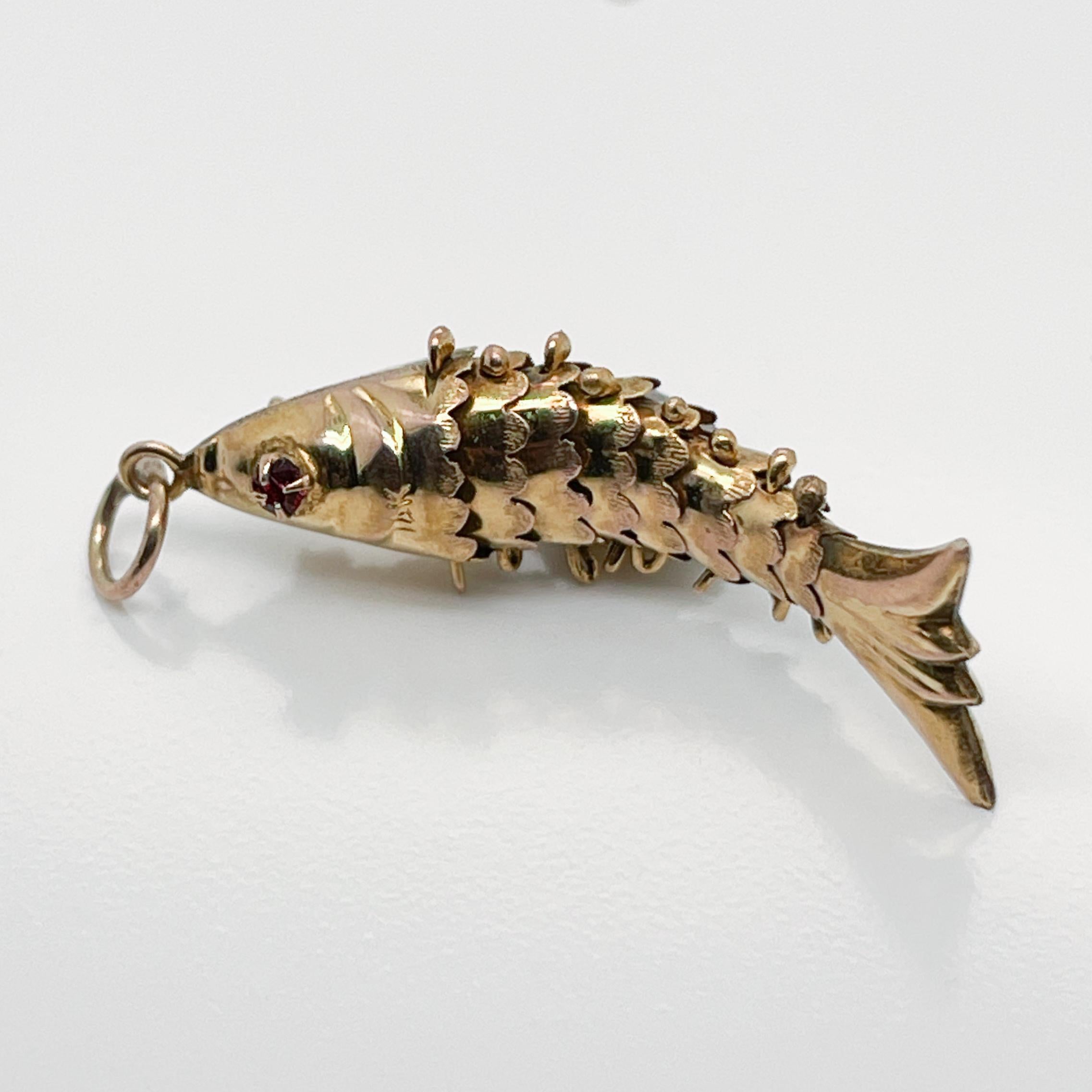 14k Gold Articulated Fish with Garnet Gemstone Eyes Charm for a Bracelet In Good Condition In Philadelphia, PA