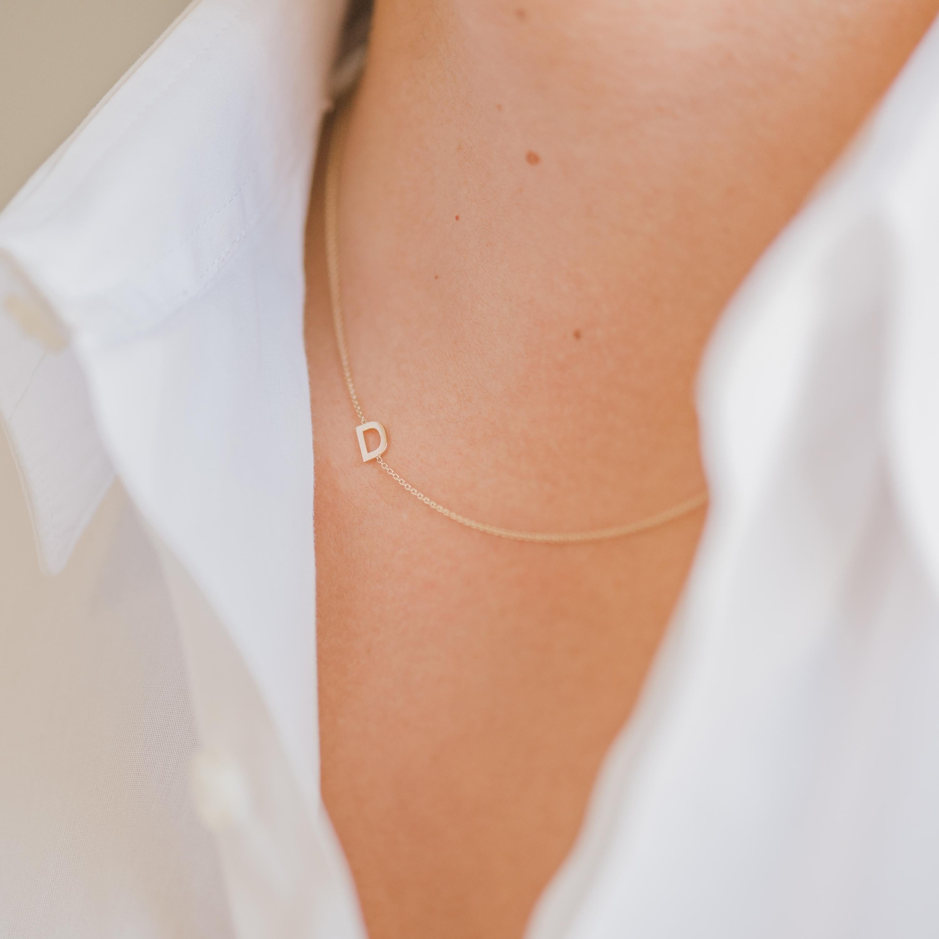 Timeless 14k solid gold asymmetrical initial on a dainty cable link chain necklace, available in 14k yellow gold. It makes for the perfect necklace with a modern twist having the initial laying sideways, wear it with your initial or your loved