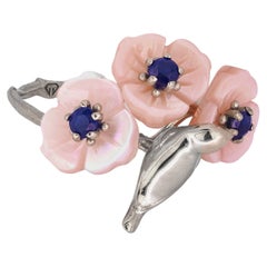 14k gold bird on branch ring with sapphires and carved mother of pearl flowers.