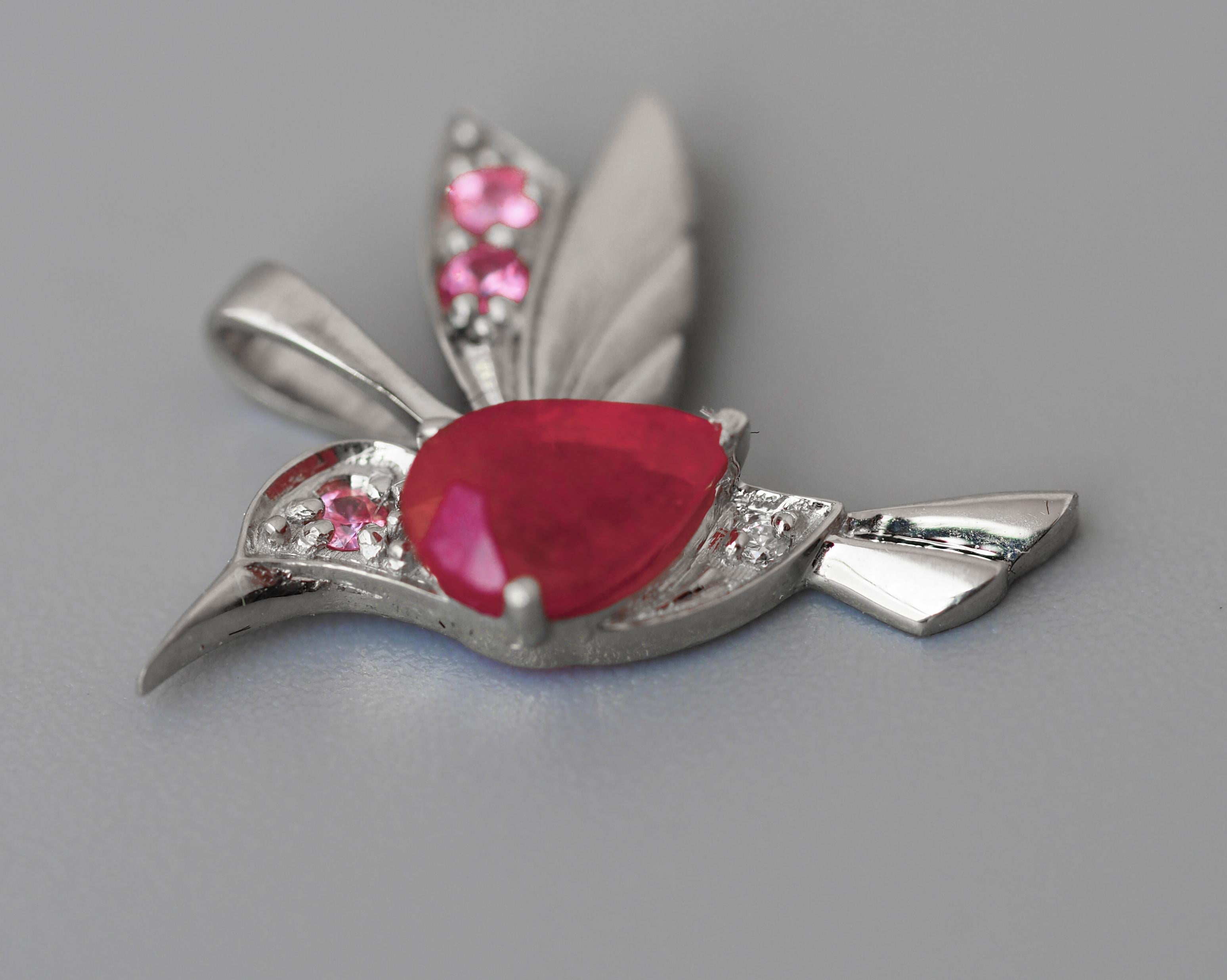 14 kt solid gold bird pendant with natural ruby, sapphires and diamond.
Weight: 0.9 g.
Size: 12 x 16.6 mm.
Set with ruby: color - red
Pear cut, 0.70 ct in total (6 x 4 mm size)
Clarity: Transparent with inclusions
3 sapphires: 2.2 mm each (0.15 ct),