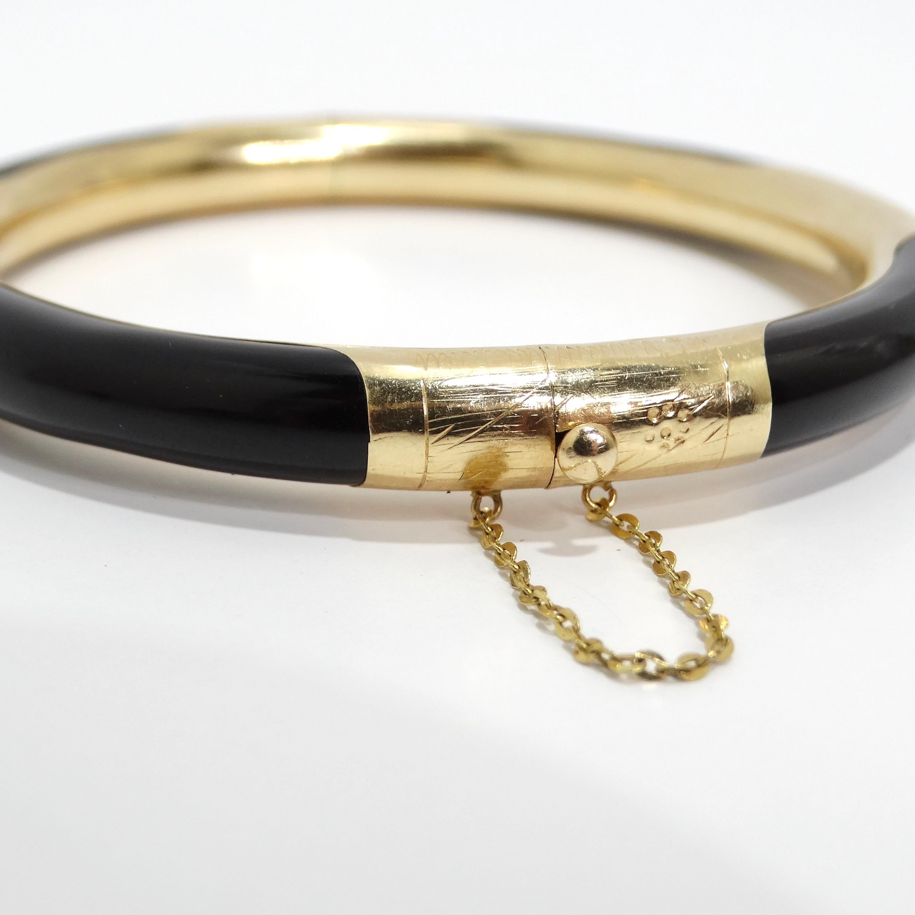 Elevate your wrist with the timeless sophistication of the 14K Gold Black Onyx Hinged Bangle Bracelet. This exquisite hinged bangle combines the opulence of luxurious black onyx with intricate 14k gold detailing, adorned with Asian decorative