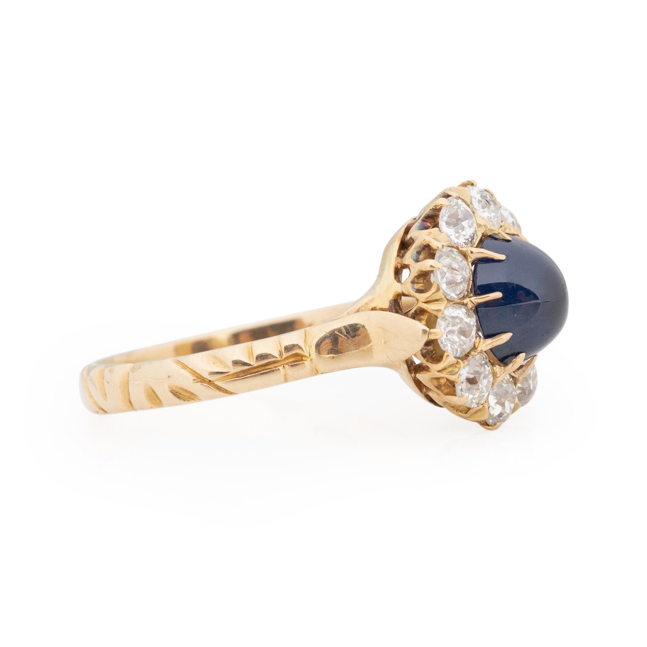 This ring has some outstanding craftsmanship. Crafted in 14K yellow gold, starting at the shank wrapping around the finger on the strait shank is an organic engraving that leads up the the cathedral shanks. In the center of the shanks is a beautiful