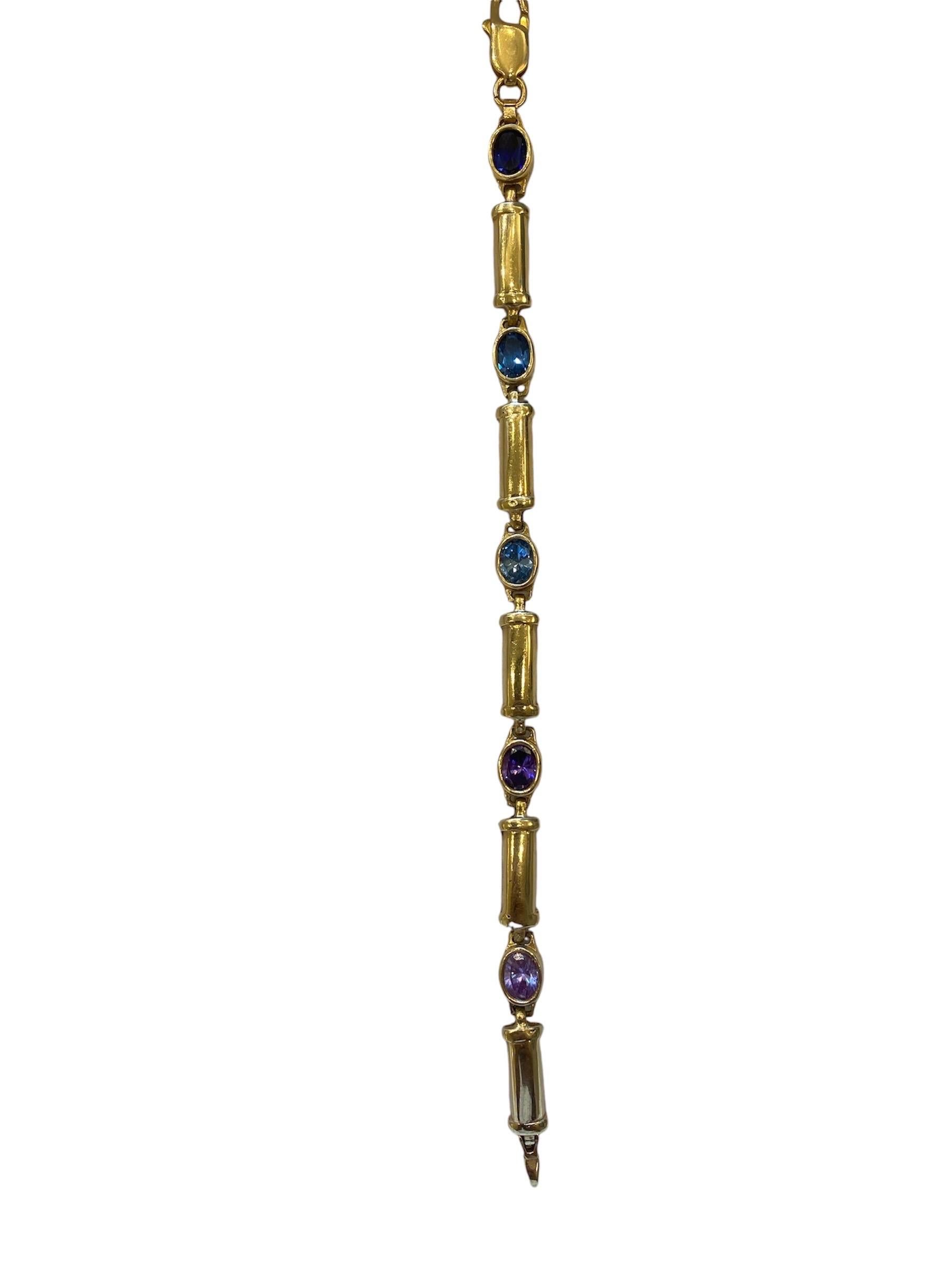 14K Golden bracelet with shiny colorful gemstones 

weight: 14.20g
length: 18 cm

This elegant 14K gold bracelet is a stunning piece of fine jewelry, featuring a delicate chain adorned with vibrant, colorful gemstones. Each gemstone is carefully set