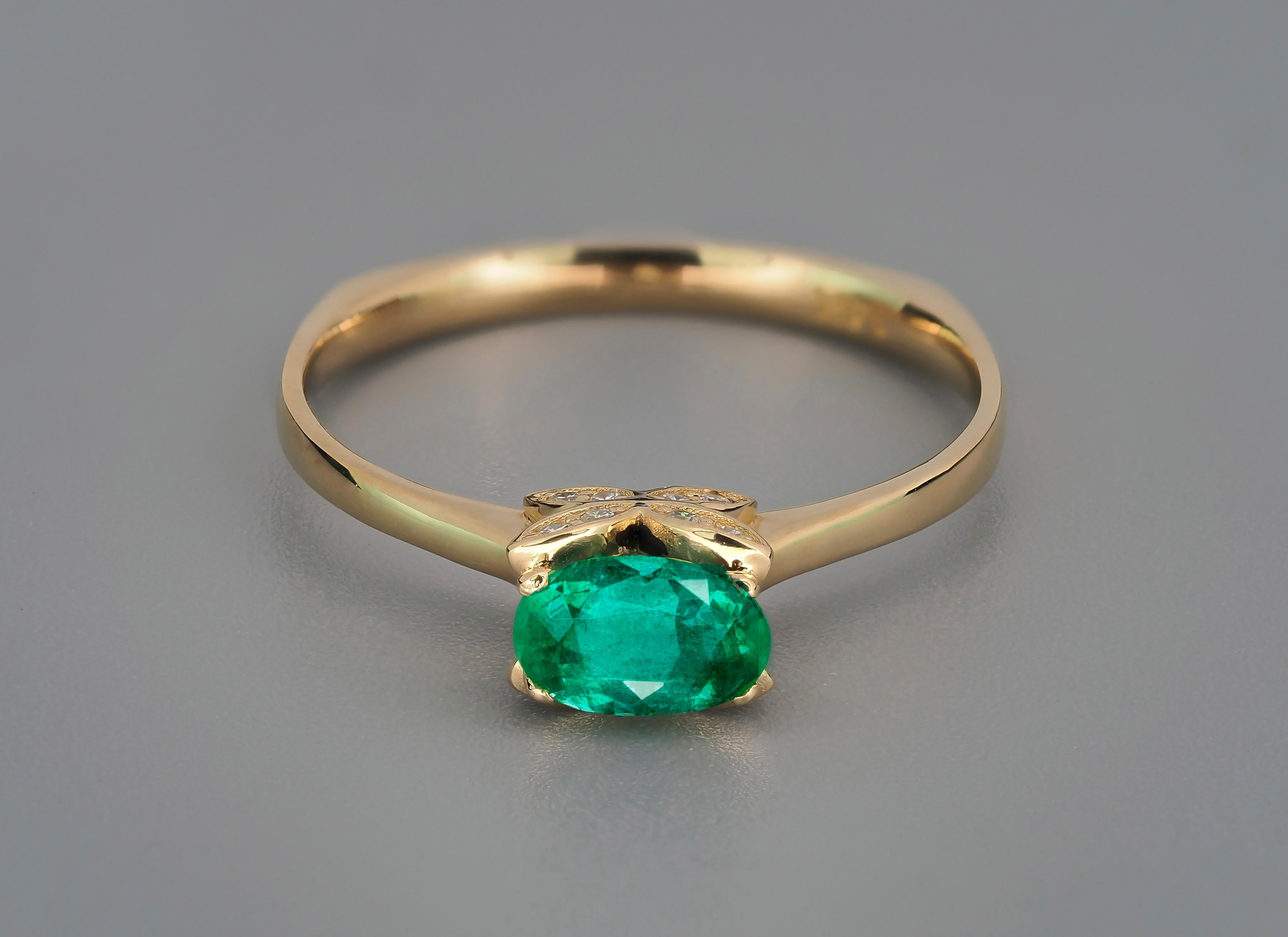 Butterfly design 14 kt gold ring with emerald and diamonds
Weight approx. 1.9 g.
Set with emerald, color - green
Oval cut, 0.80 ct. 
Clarity: Transparent with inclusions (emerald garden)
Surrounding stone - diamonds (F/VS), round brilliant cut,