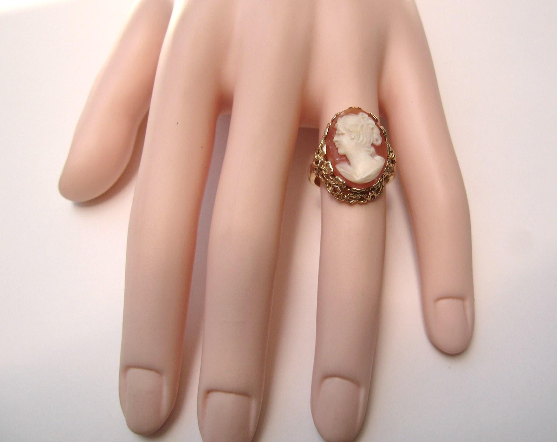 Intricate scroll design on this 14K Gold Cameo Ring. The ring is a size 7 and can be size by us or your jeweler. Sits up about .28